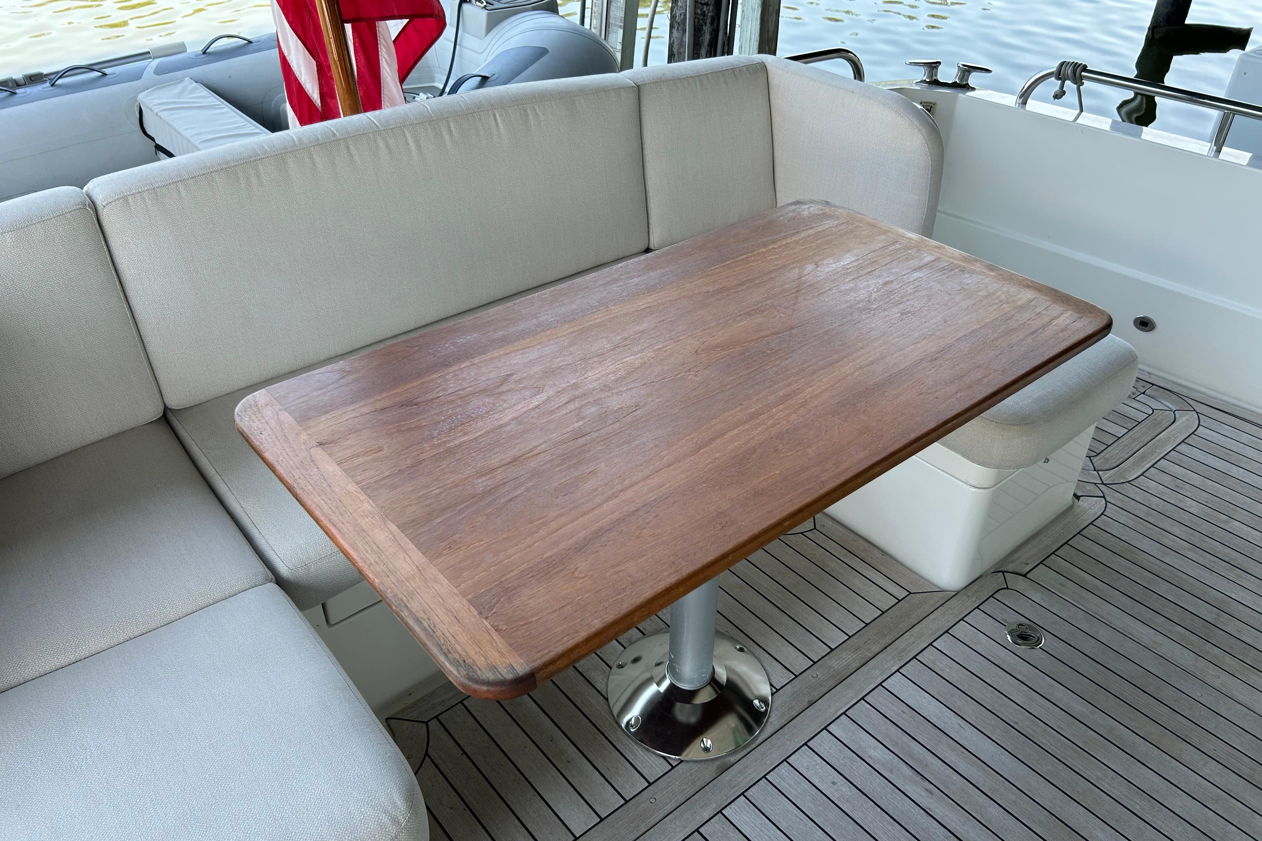 Luxury seating area on 2022 Sabre 45 Salon Express yacht with wooden table.
