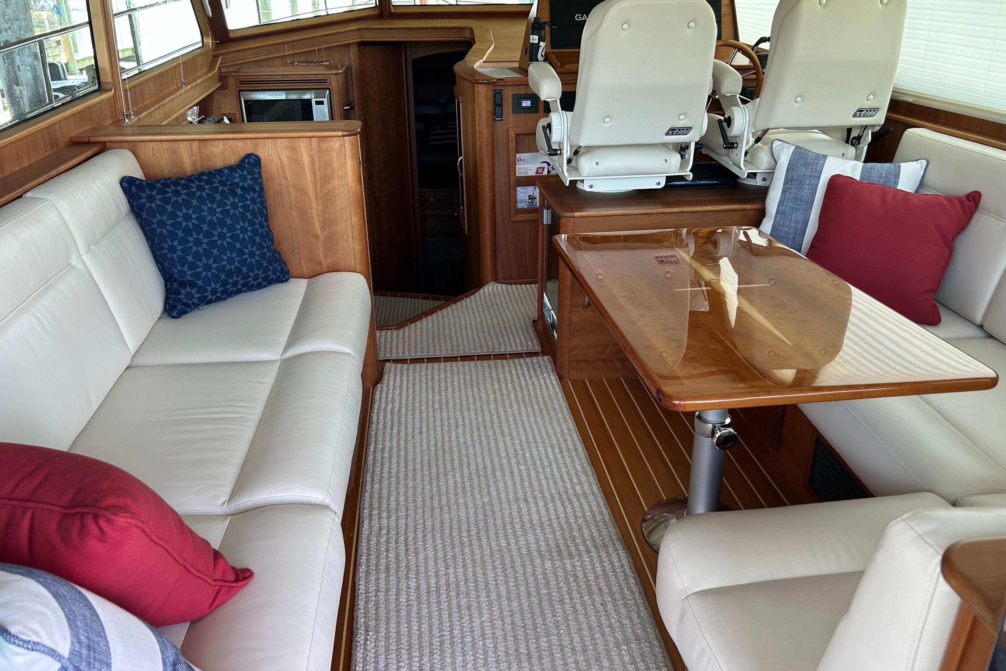Luxurious interior of 2022 Sabre 45 Salon Express yacht with elegant seating and wooden table.