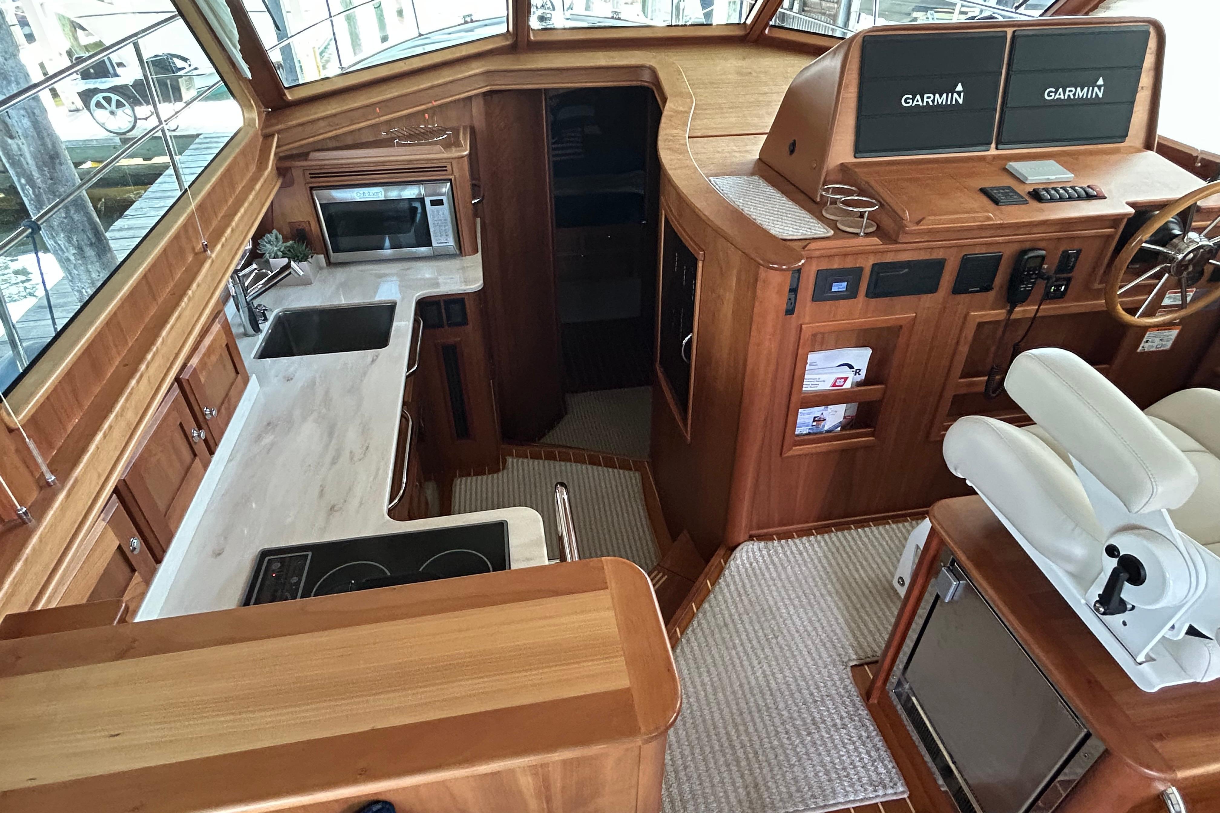 Interior of 2022 Sabre 45 Salon Express yacht with modern kitchen and navigation equipment.