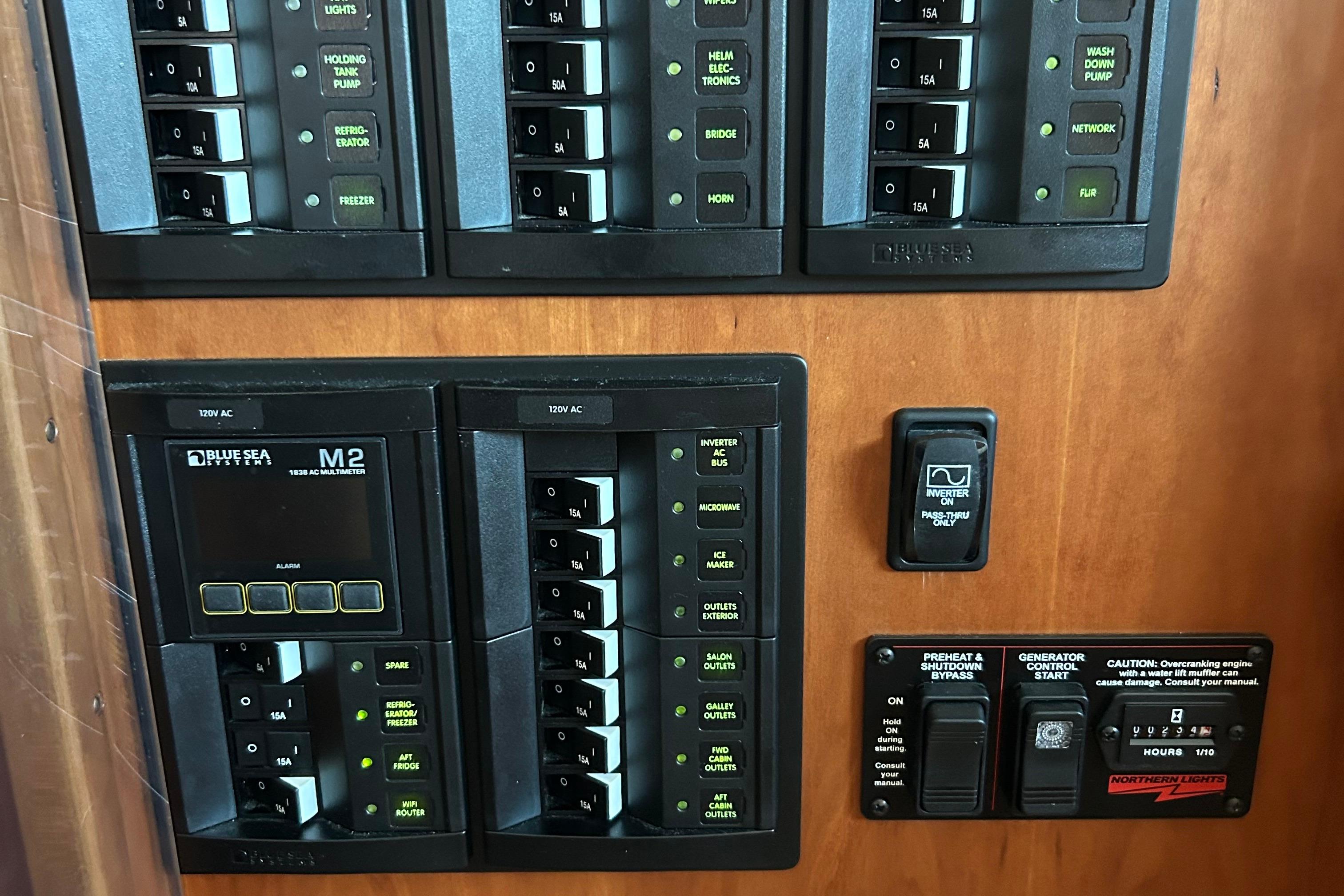 Control panel of a 2022 Sabre 45 Salon Express yacht with various switches and indicators.