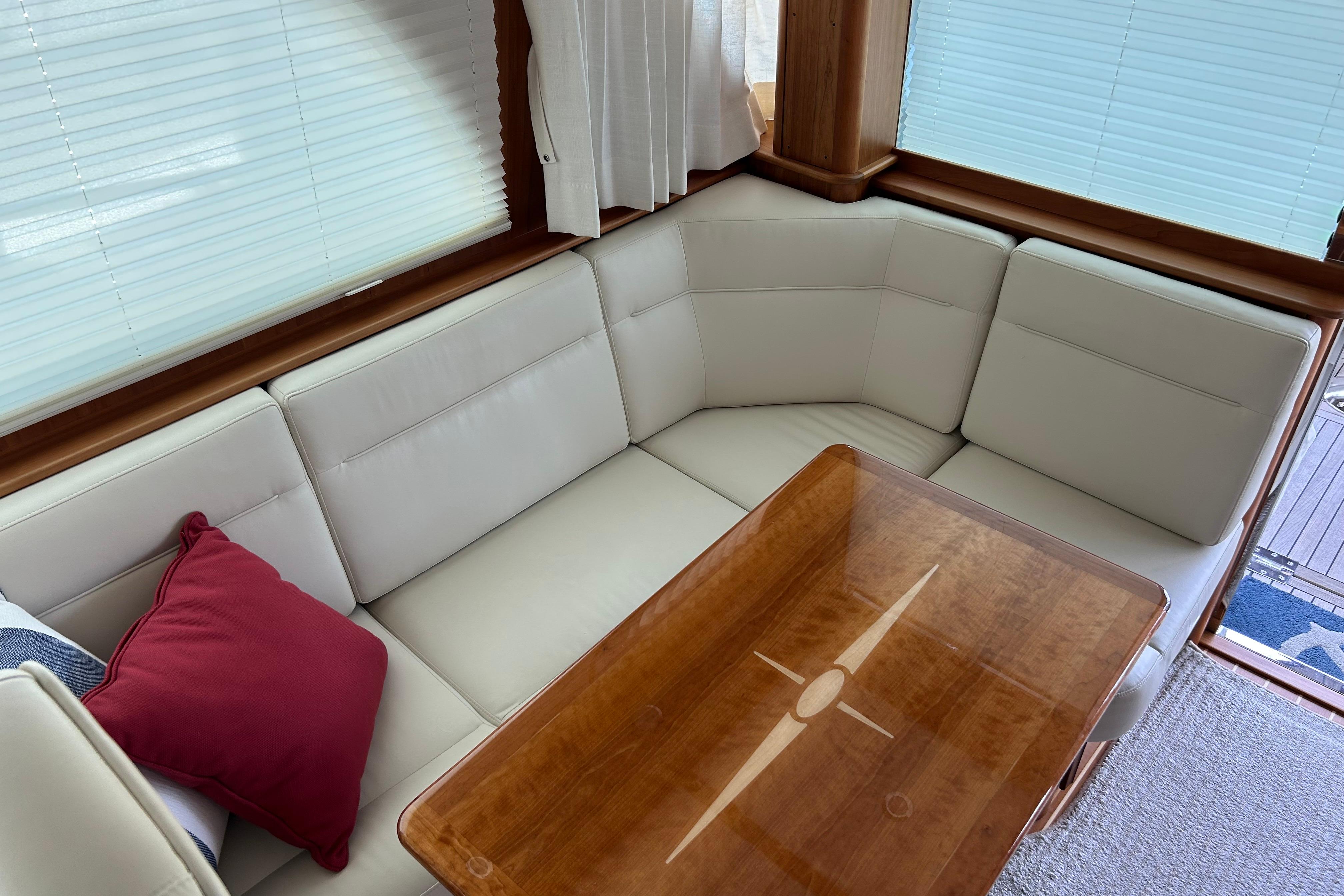 Luxurious interior of 2022 Sabre 45 Salon Express with elegant seating and wooden table.