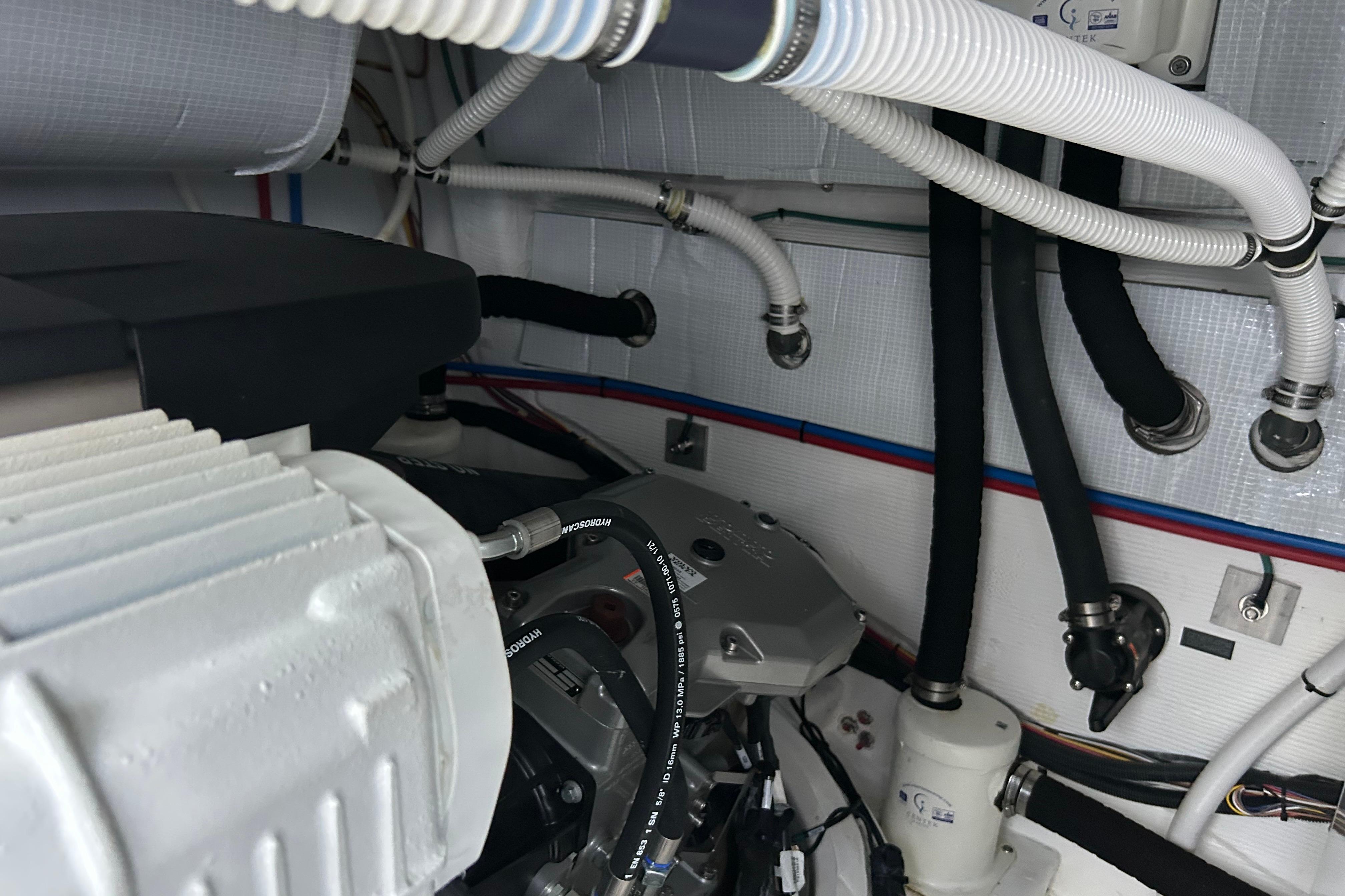 Engine room of 2022 Sabre 45 Salon Express with visible hoses and components.