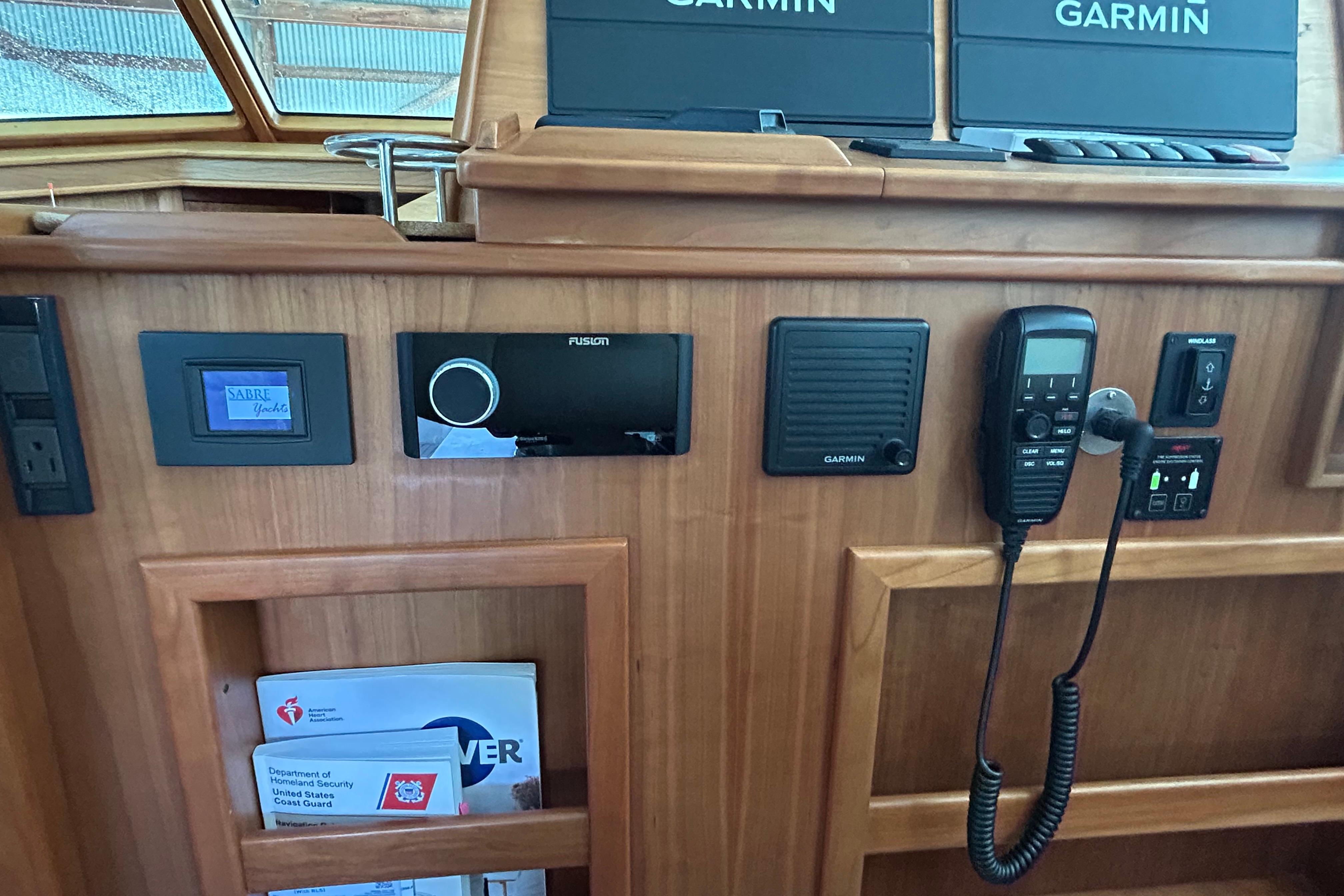 2022 Sabre 45 Salon Express yacht dashboard with Garmin electronics and communication devices.