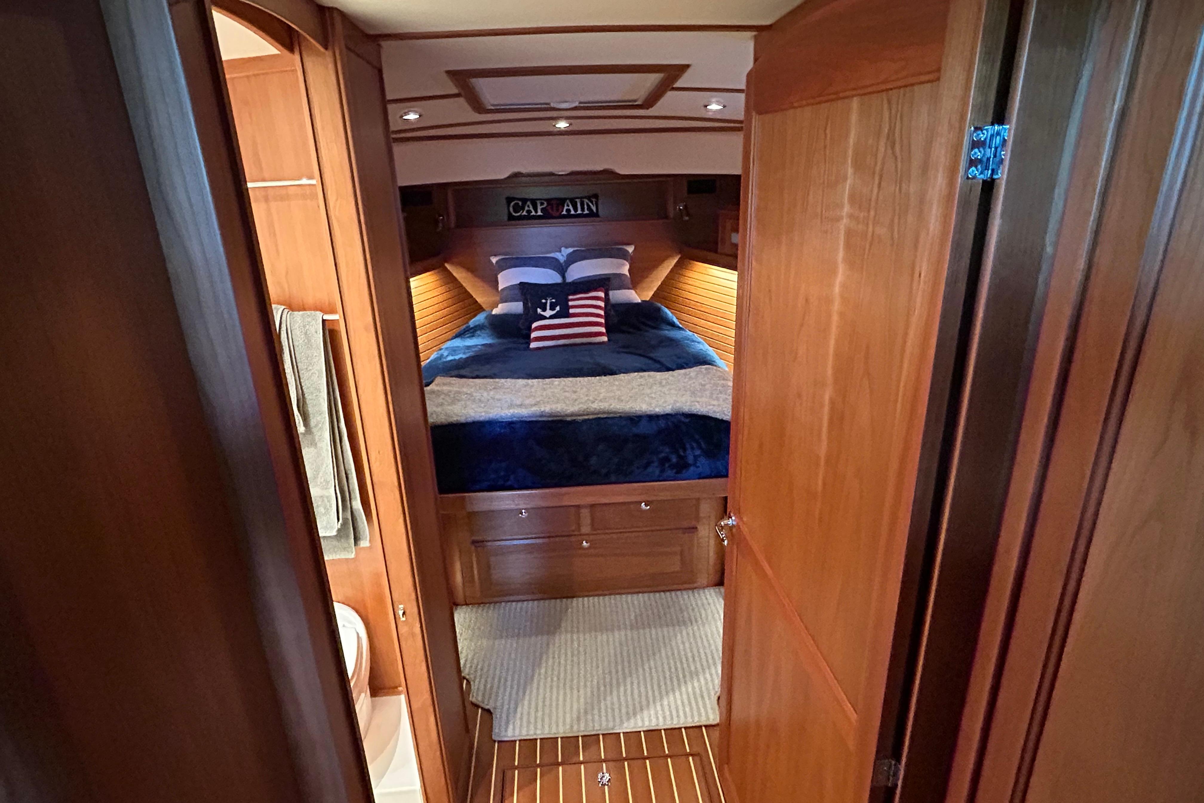 Interior of 2022 Sabre 45 Salon Express yacht, featuring cozy bedroom with nautical decor.