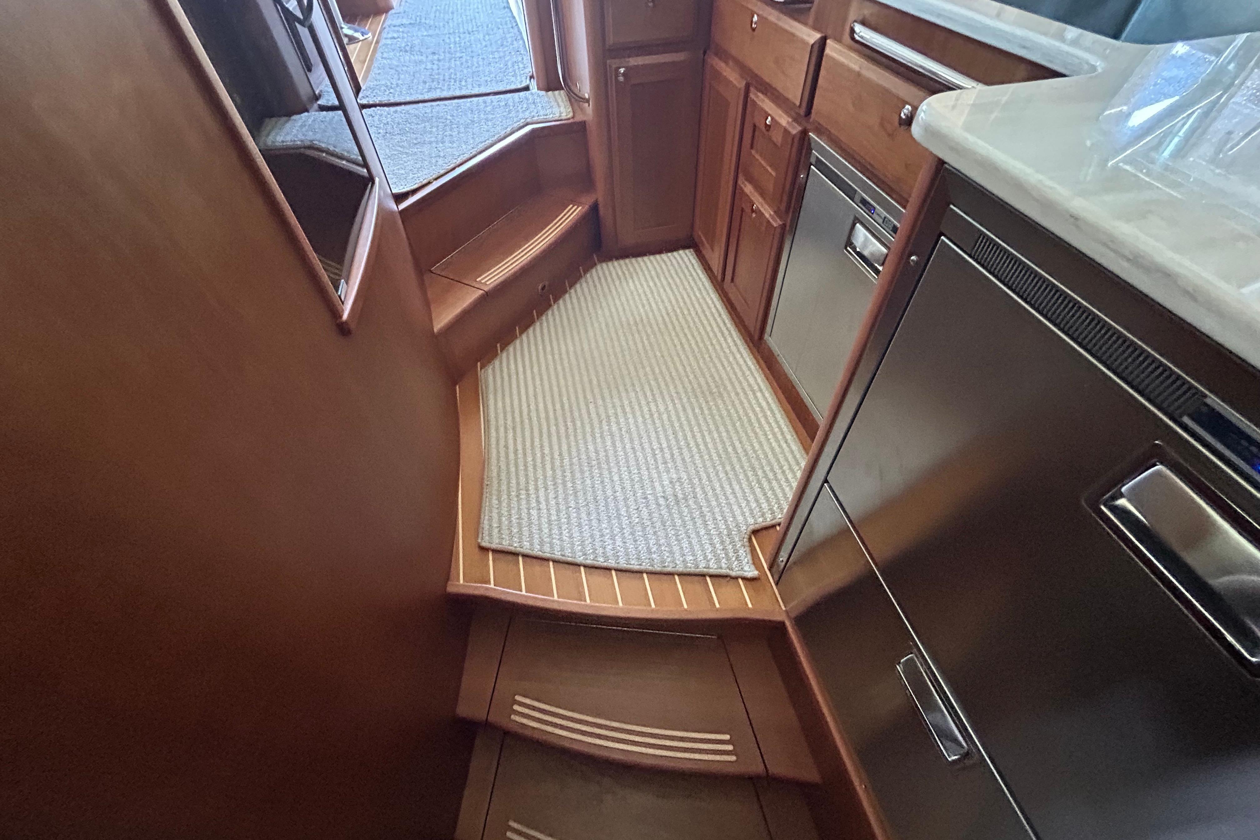 Interior of 2022 Sabre 45 Salon Express yacht, featuring elegant wood cabinetry and modern appliances.