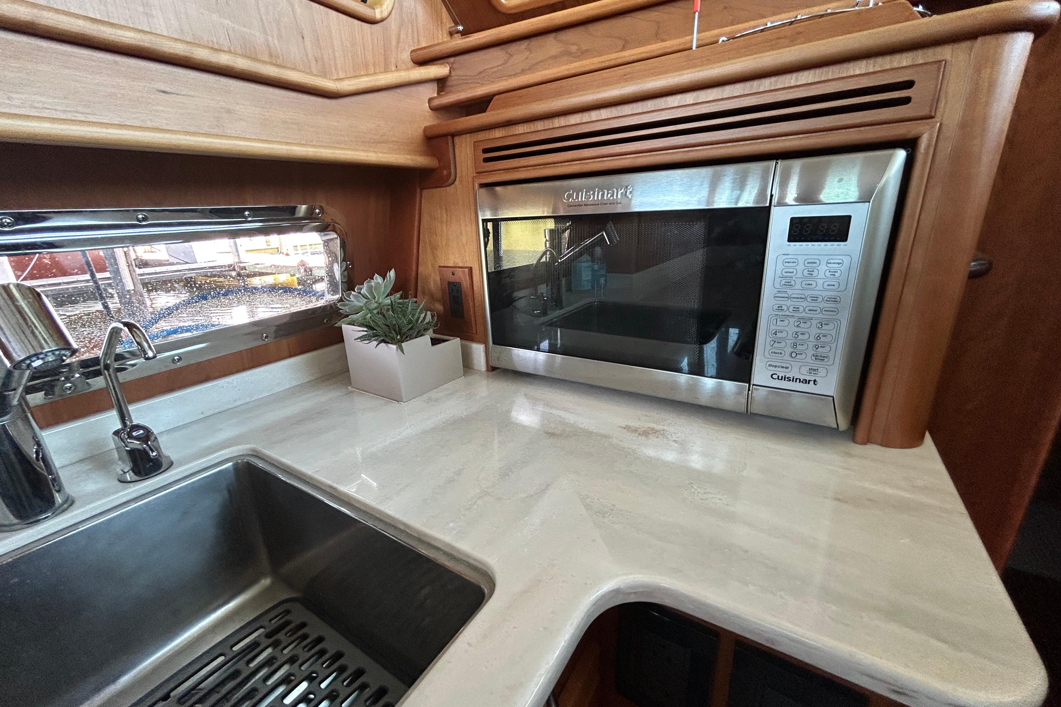 Modern kitchen in 2022 Sabre 45 Salon Express with microwave and sink.