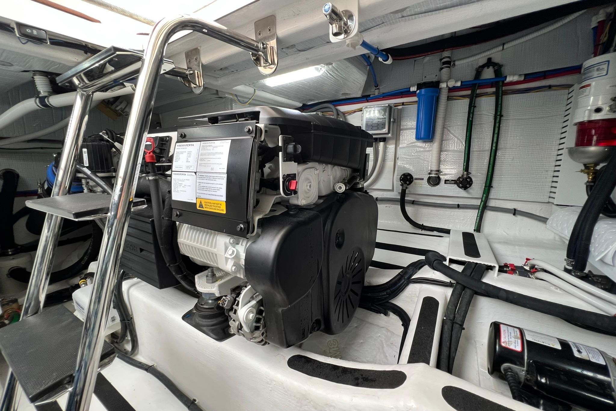 Engine room of 2022 Sabre 45 Salon Express with visible generator and piping.