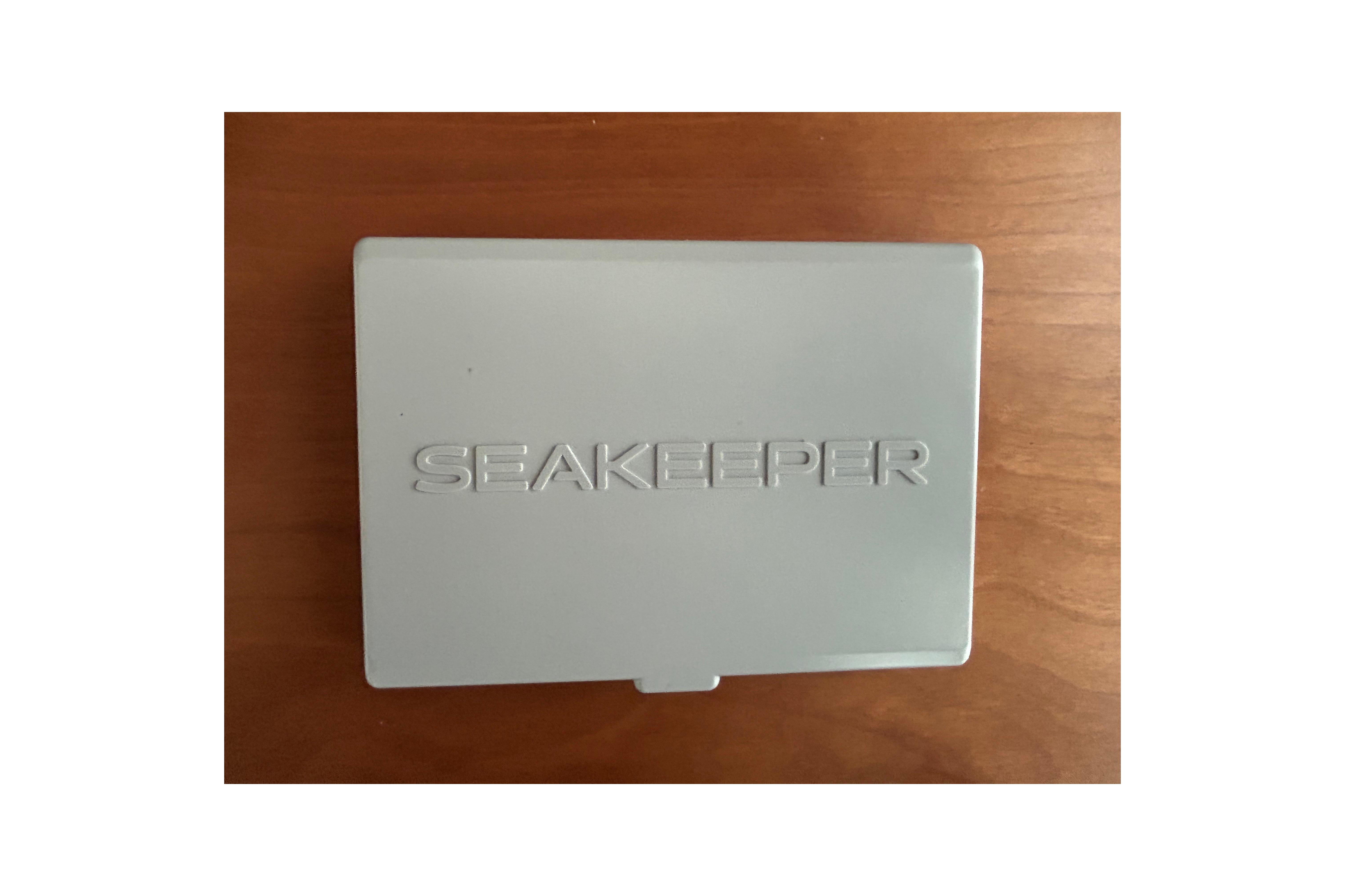 Seakeeper control panel on Sabre 45 Salon Express 2022 yacht, wooden background.