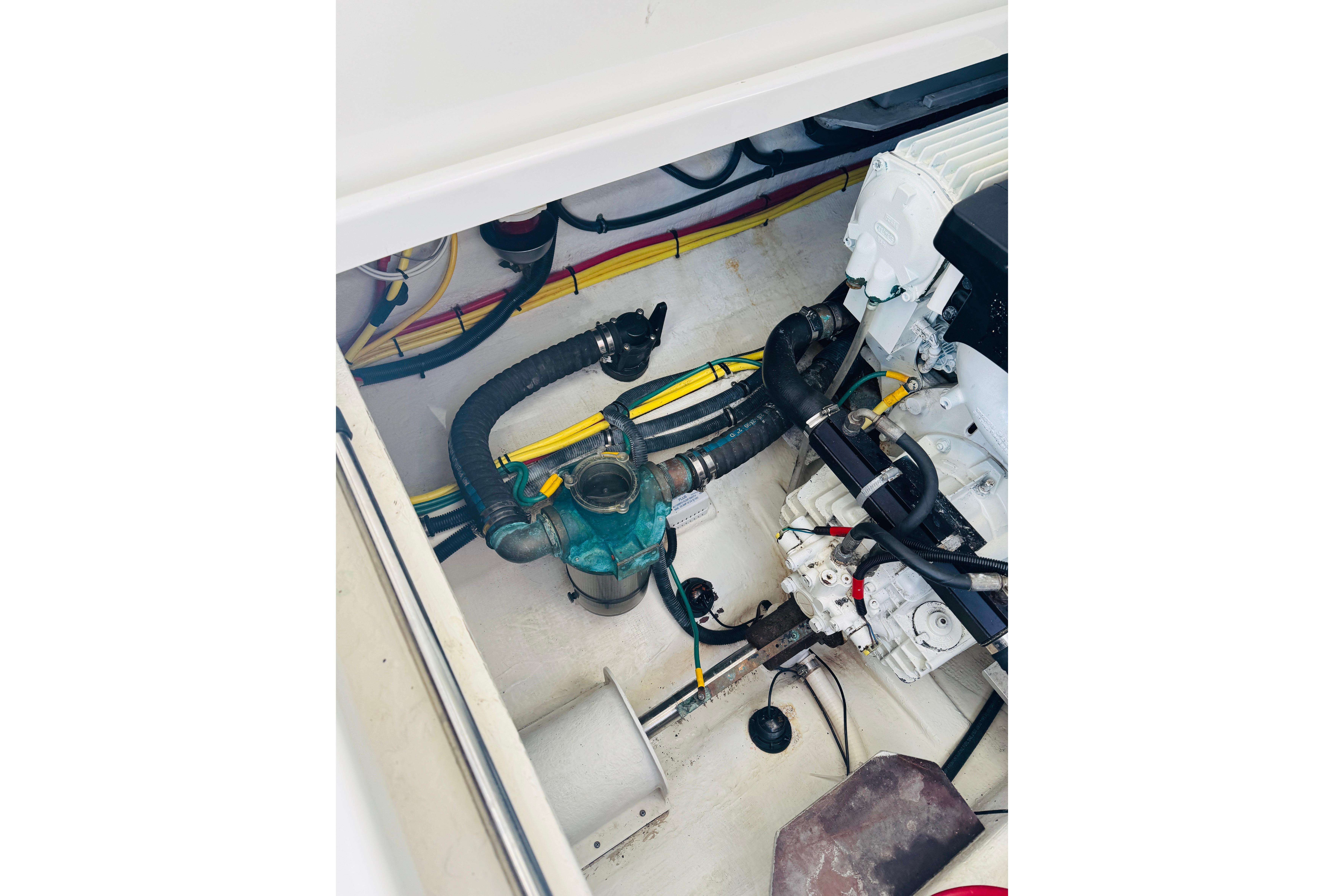 Engine compartment of a 2007 Back Cove 29 boat, showing hoses and wiring.