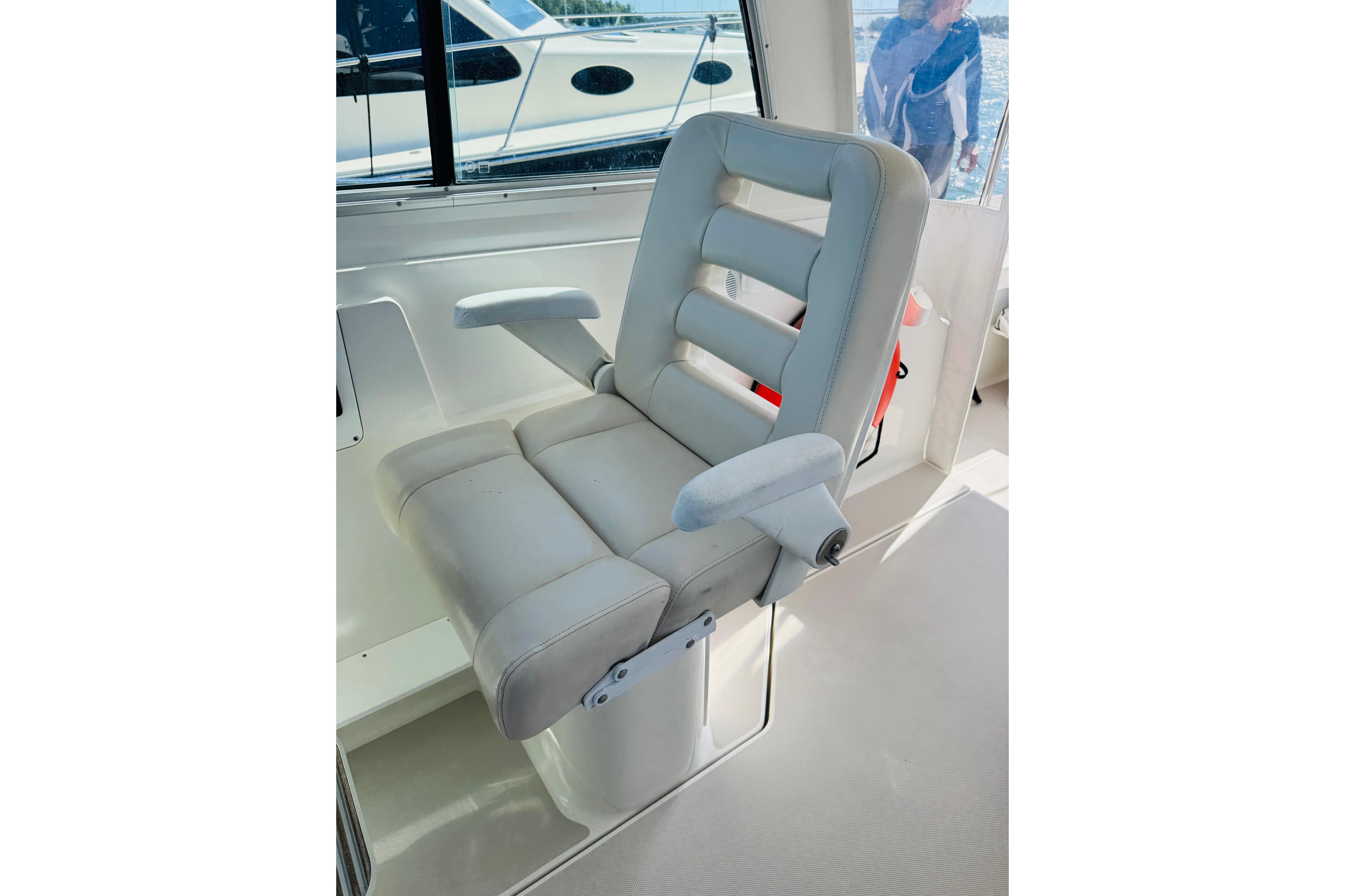 Captainu0027s chair on a 2007 Back Cove 29 boat, featuring cushioned armrests and sleek design.