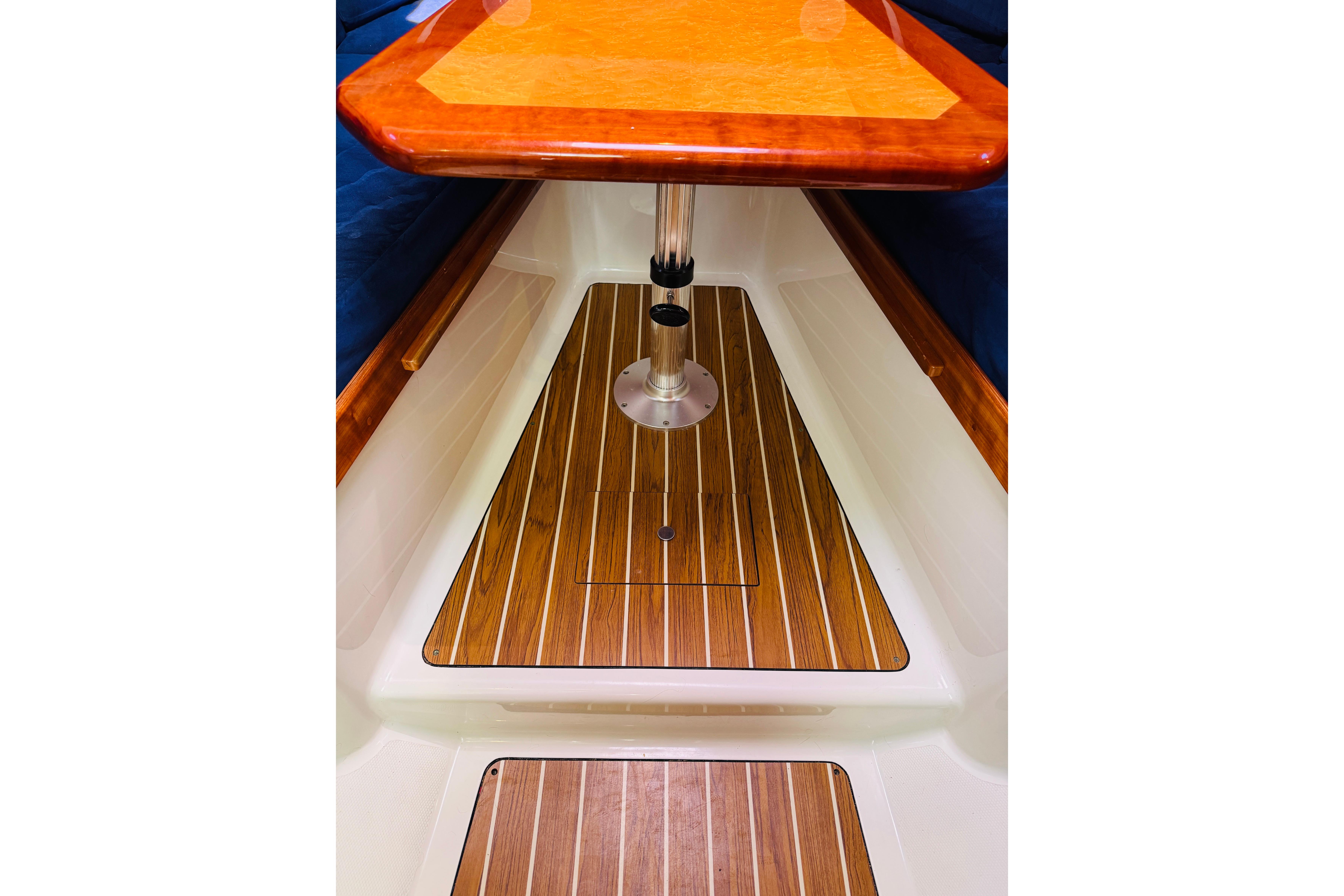 2007 Back Cove 29 interior with wooden flooring and table.