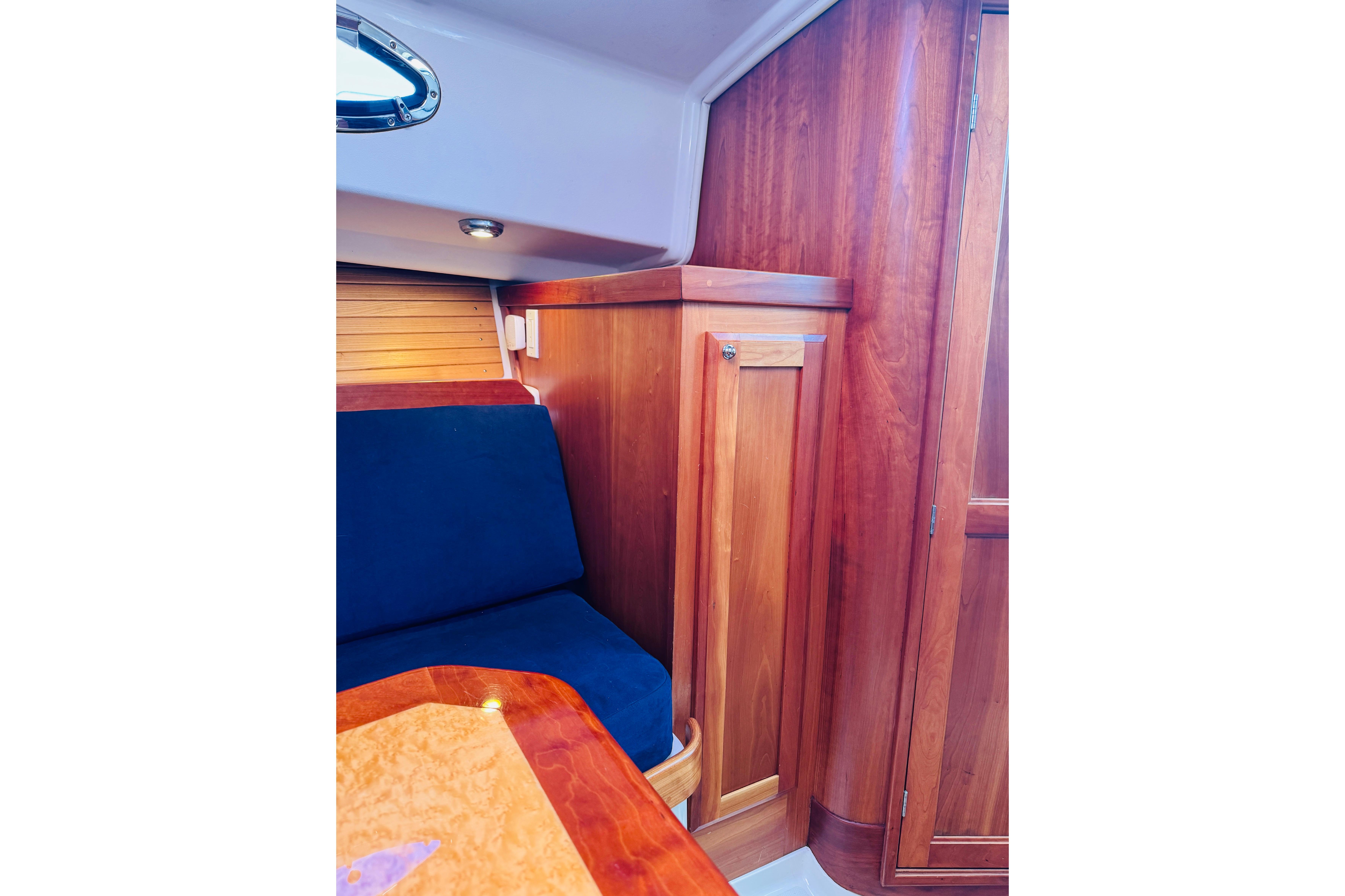 2007 Back Cove 29 interior with wooden cabinetry and blue seating.