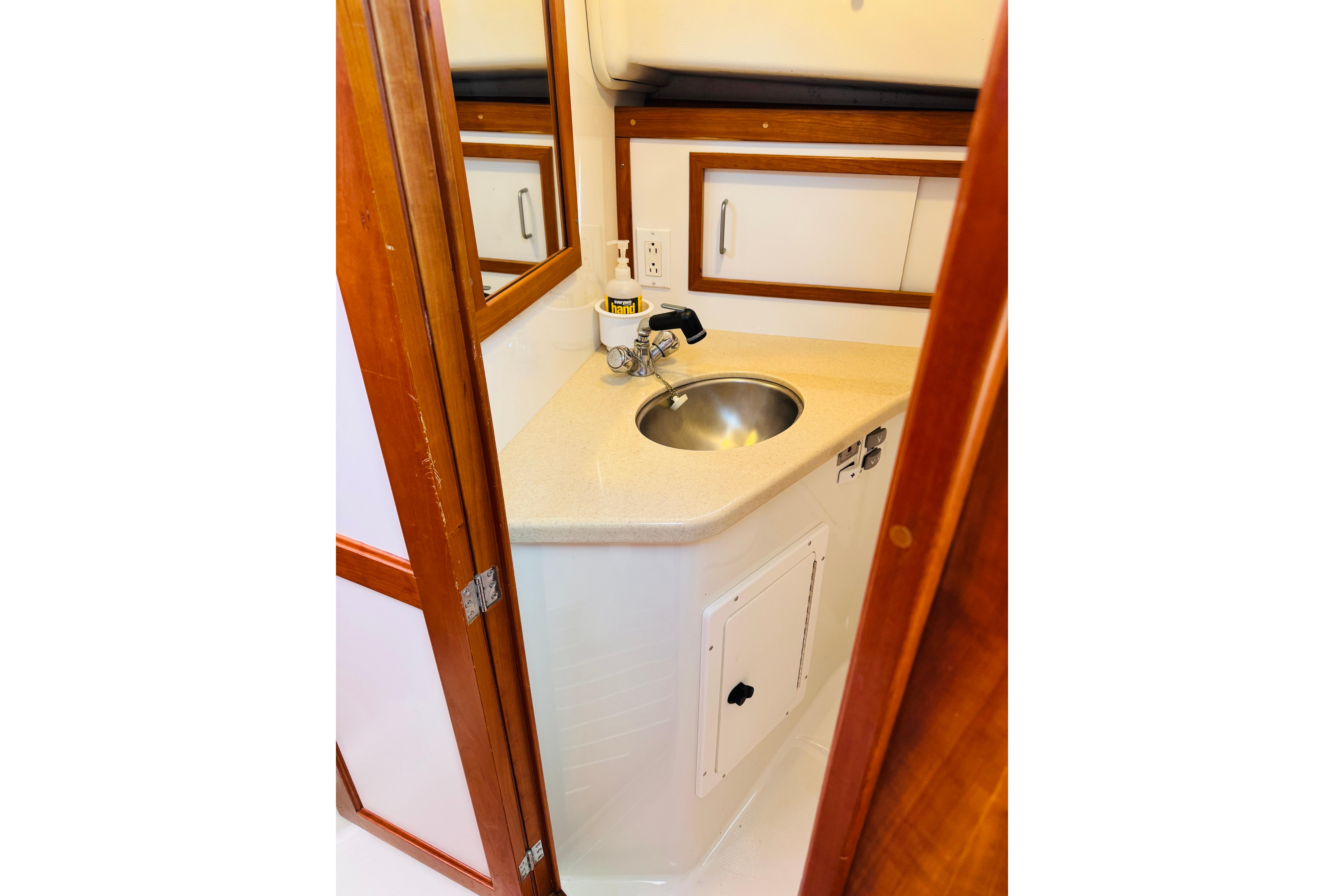 2007 Back Cove 29 boat interior with compact sink and wooden cabinetry.