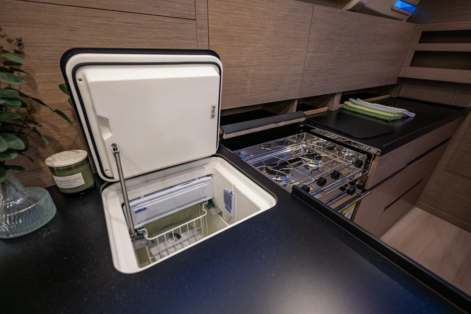 Hanse-418 2023-SEA #304 IN STOCK WA-US-Modern kitchen interior of 2023 Hanse 418 yacht with open fridge and stove.-9568627 | Thumbnail