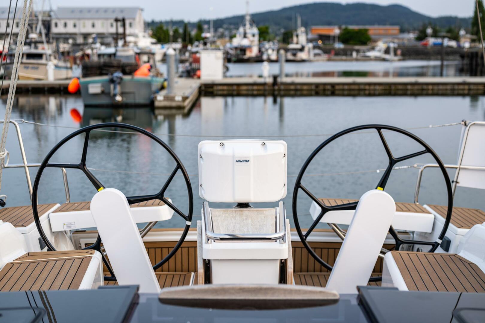 Hanse-418 2023-SEA #304 IN STOCK WA-US-2023 Hanse 418 yacht cockpit with dual steering wheels at a marina.-9568627 | Thumbnail