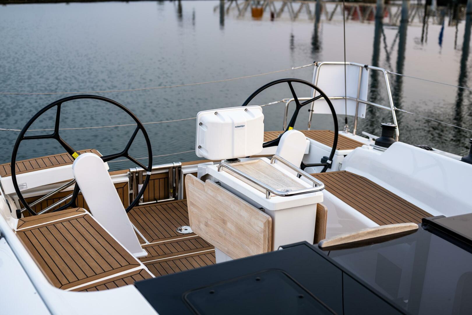 Hanse-418 2023-SEA #304 IN STOCK WA-US-Hanse 418 yacht cockpit with dual steering wheels, 2023 model, docked by calm waters.-9568627 | Thumbnail