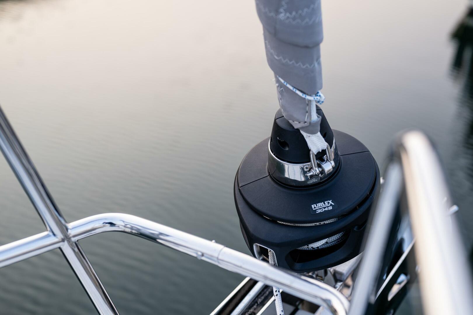 Hanse-418 2023-SEA #304 IN STOCK WA-US-Close-up of a 2023 Hanse 418 sailboat winch and railing over water.-9568627 | Thumbnail