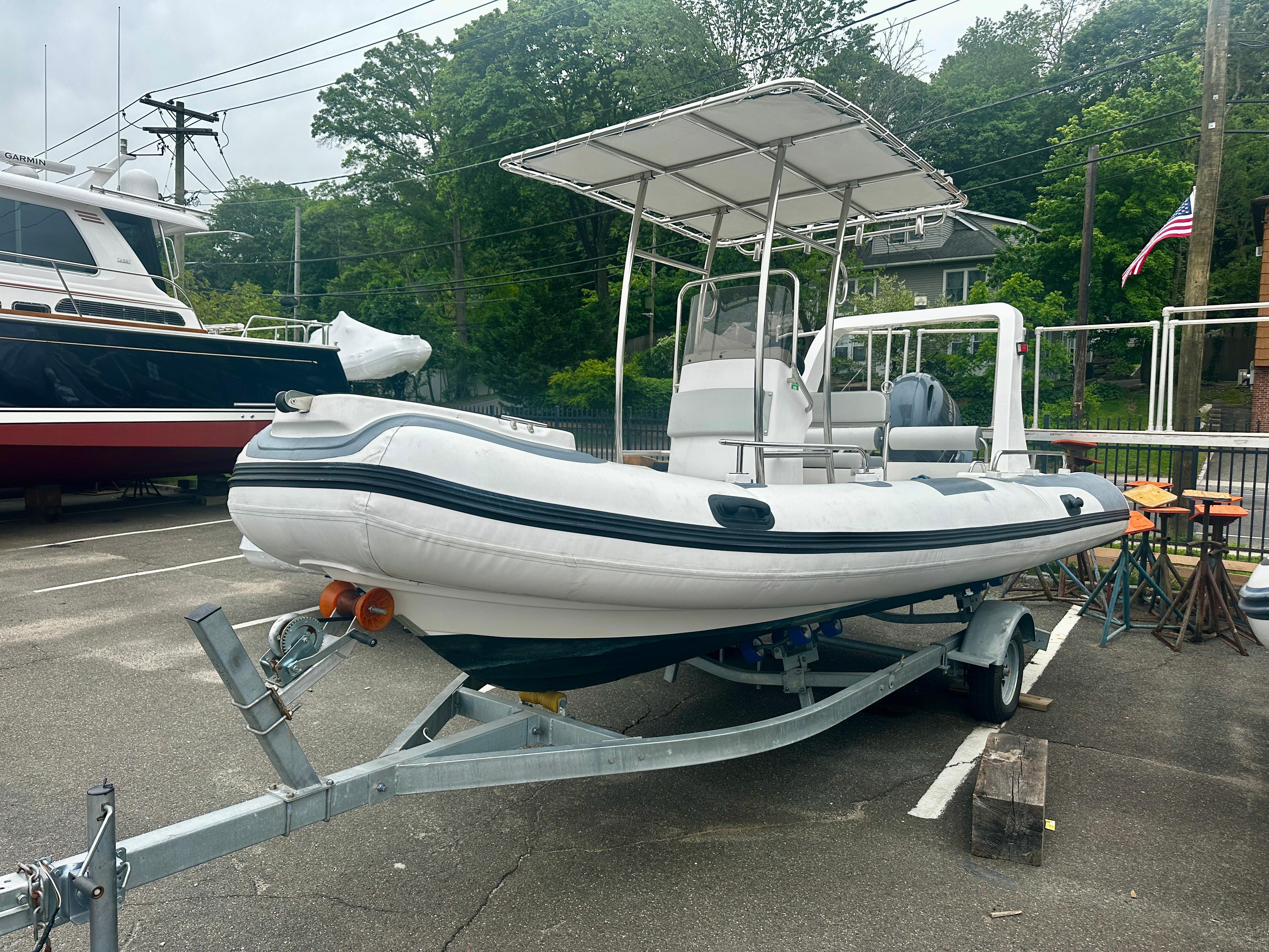 2021 Hedia Rib580 boat on trailer in a parking lot.