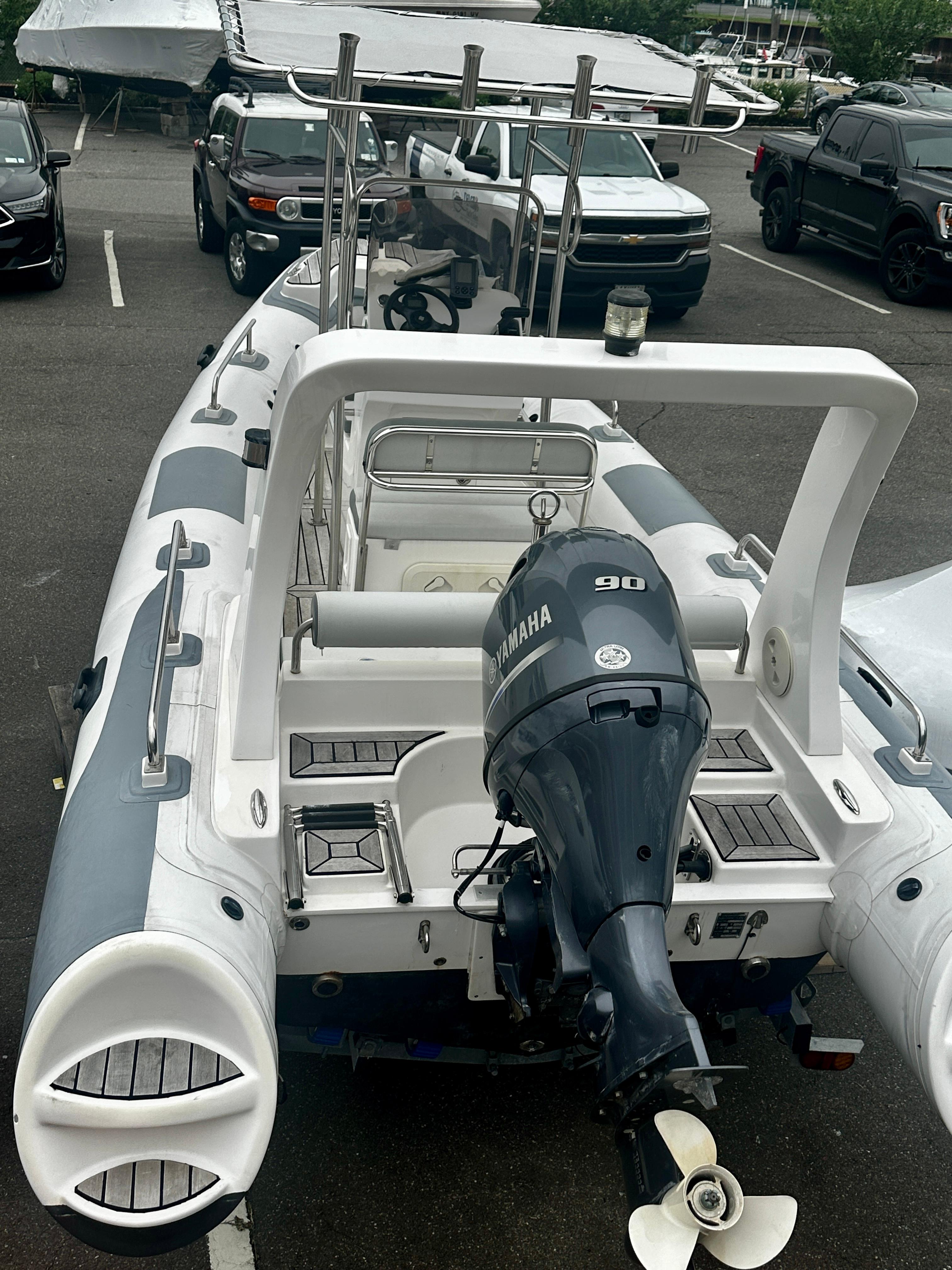 2021 Hedia Rib580 boat with Yamaha 90 engine in parking lot.