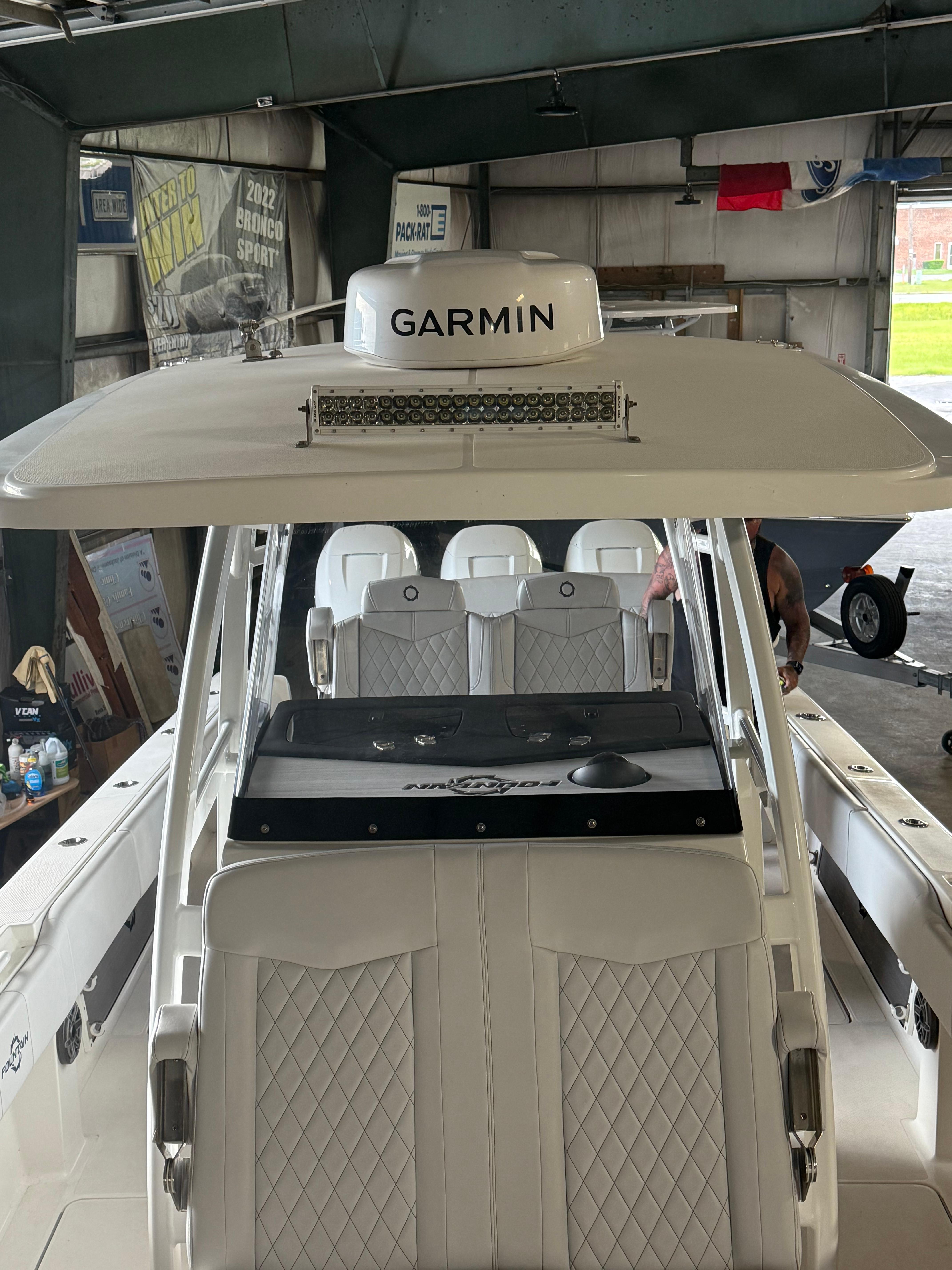 Fountain-34 CC 2023-FOUNTAIN 34 CC FL-US-2023 Fountain 34 CC boat with Garmin equipment, featuring luxurious seating in a garage.-9786946 | Thumbnail