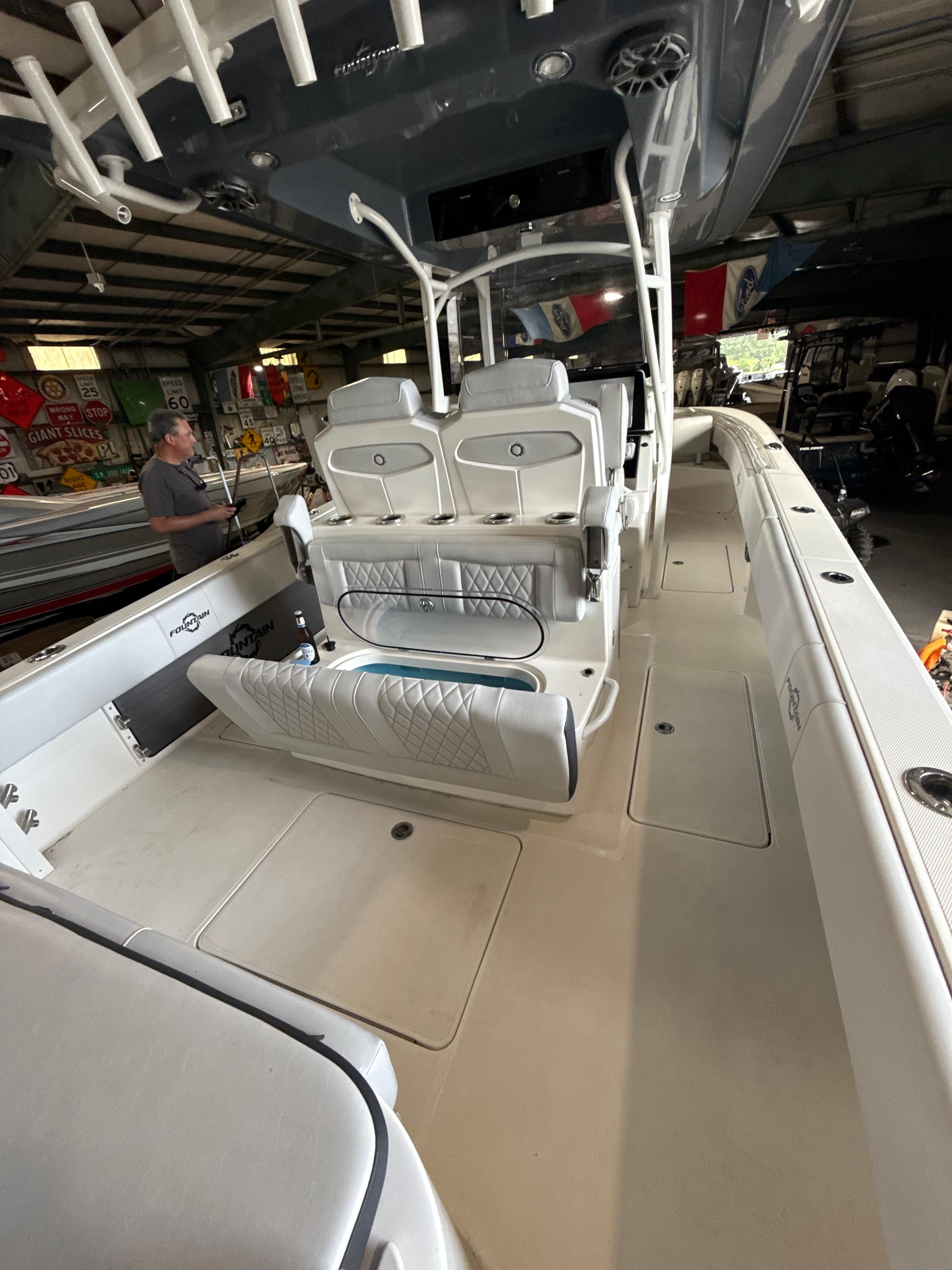 Fountain-34 CC 2023-FOUNTAIN 34 CC FL-US-2023 Fountain 34 CC boat interior with seating and storage in a garage setting.-9786946 | Thumbnail