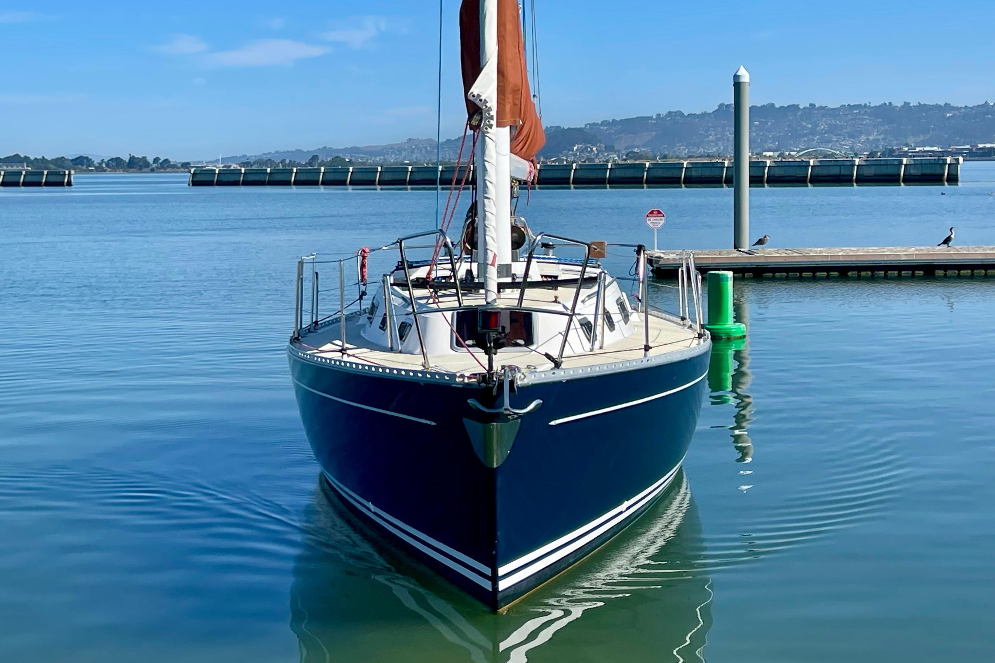 Sailboat Freedom 35, 1995 model, docked in calm marina waters.