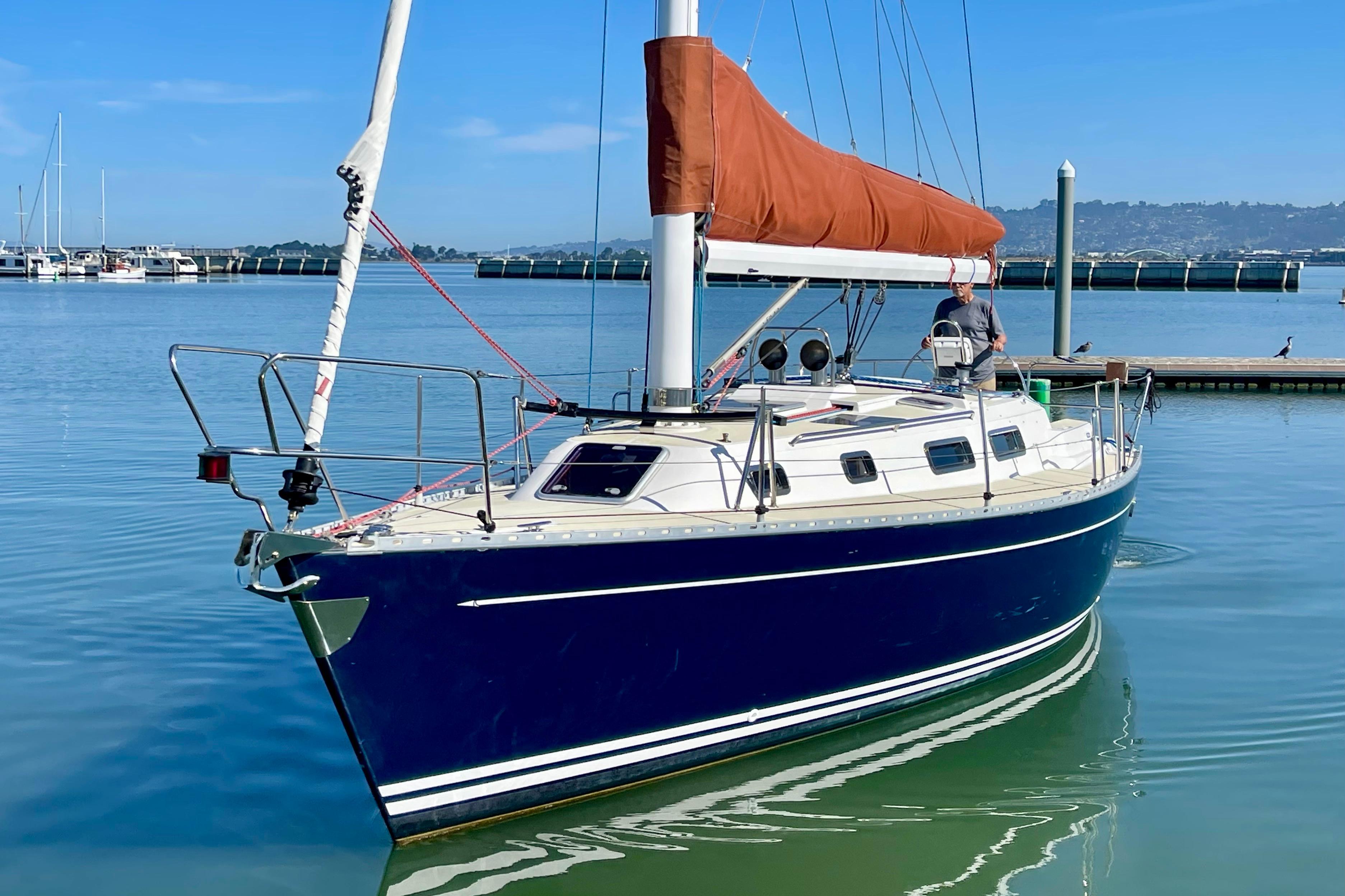 Sailboat Freedom 35, 1995 model, docked in calm marina waters.