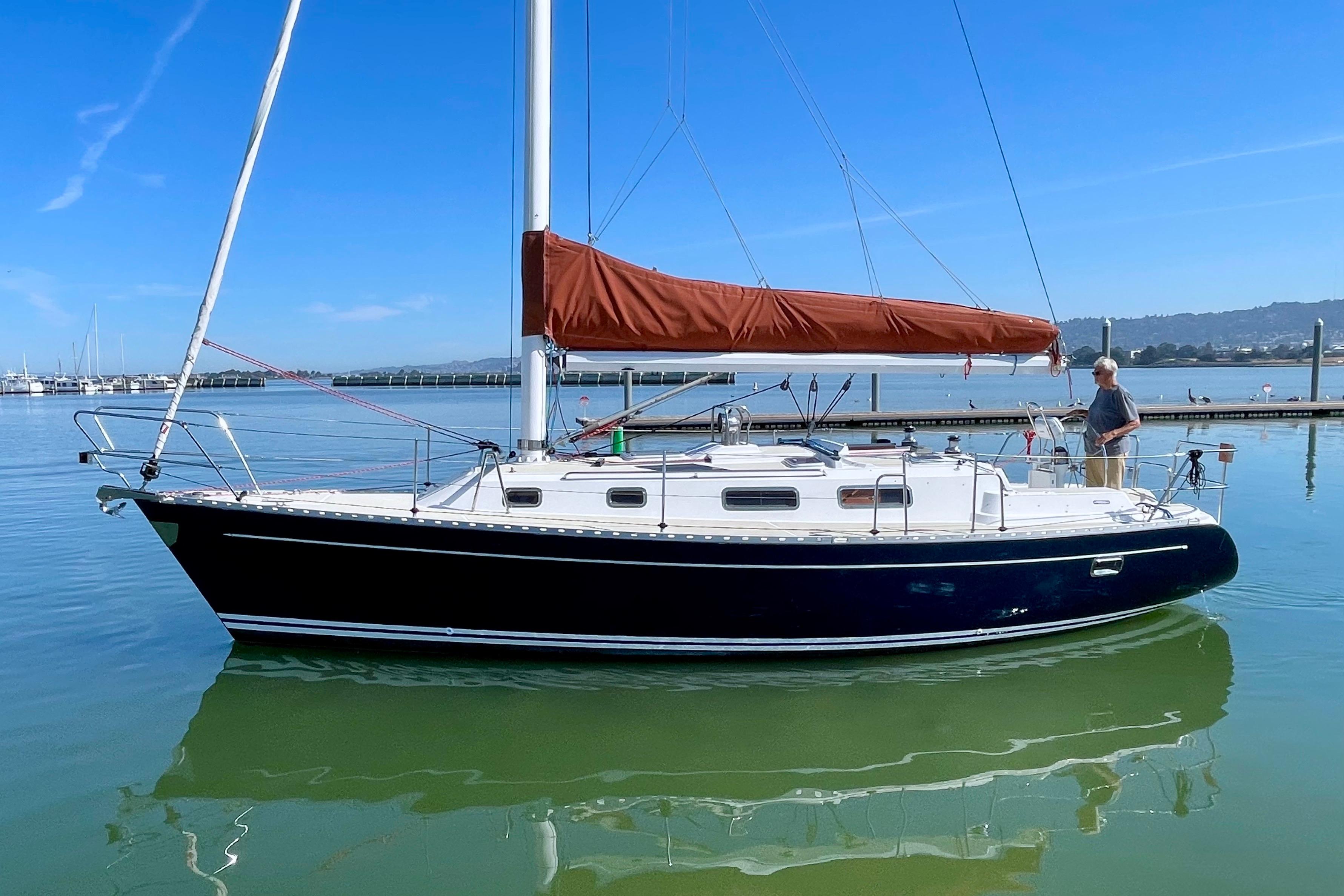 Sailboat Freedom 35, 1995 model, docked in calm waters under clear blue sky.