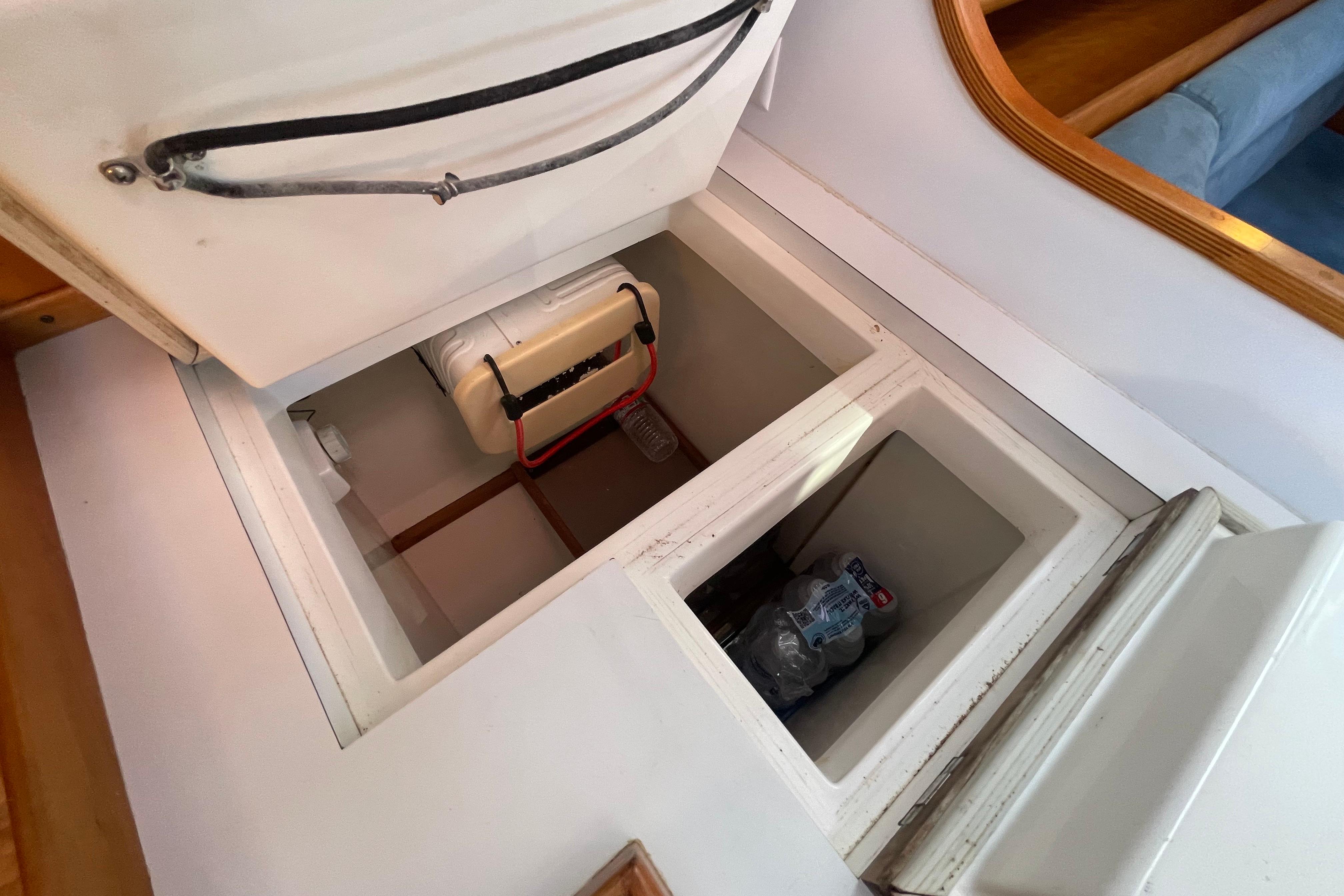 Open storage compartment in 1995 Freedom 35 boat interior, showing organized space and equipment.