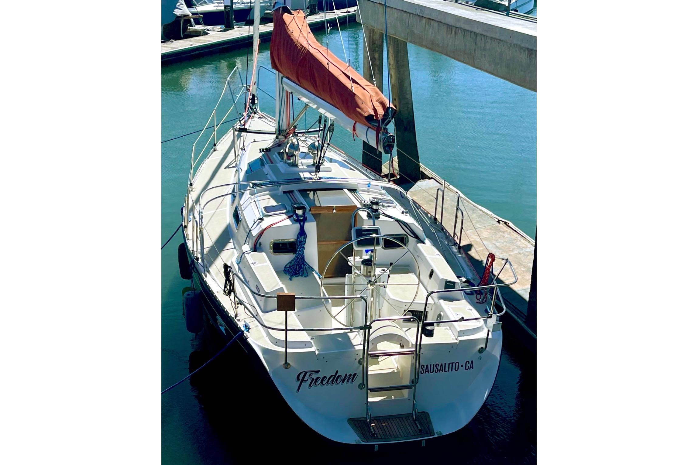Sailboat "Freedom 35" from 1995 docked in Sausalito, CA marina.