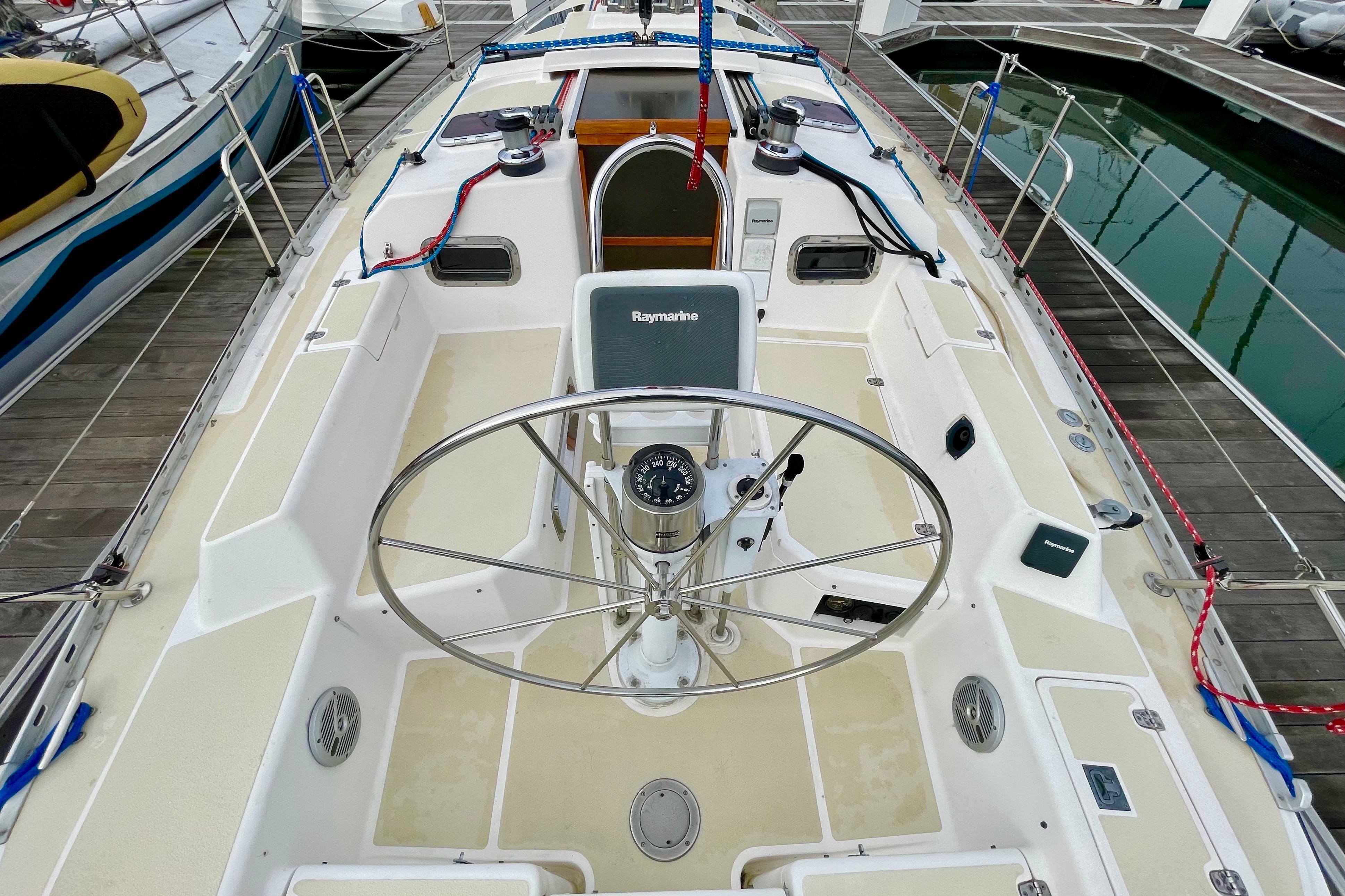 Cockpit of 1995 Freedom 35 sailboat with steering wheel and navigation equipment.