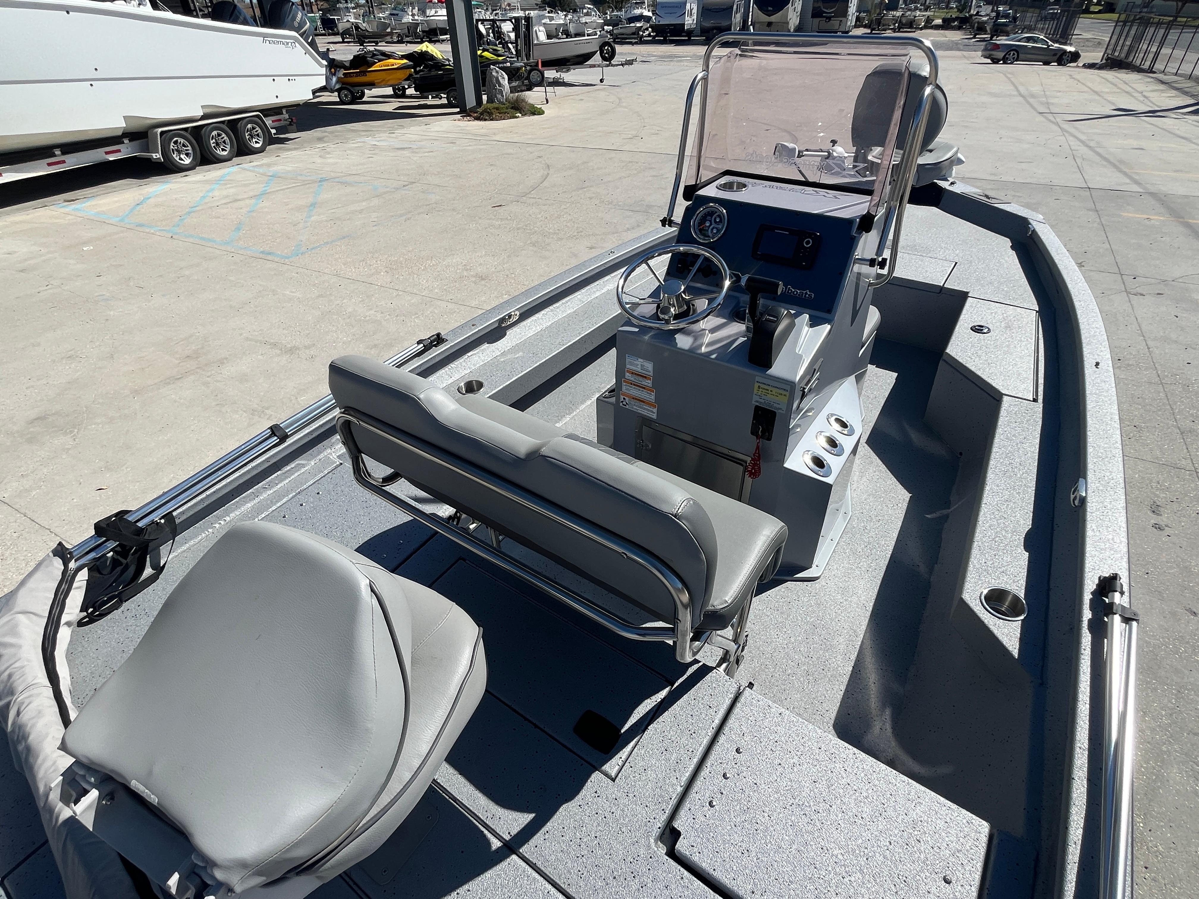 2022 Xpress H20B Bay Boat with console and seating, docked in a marina.