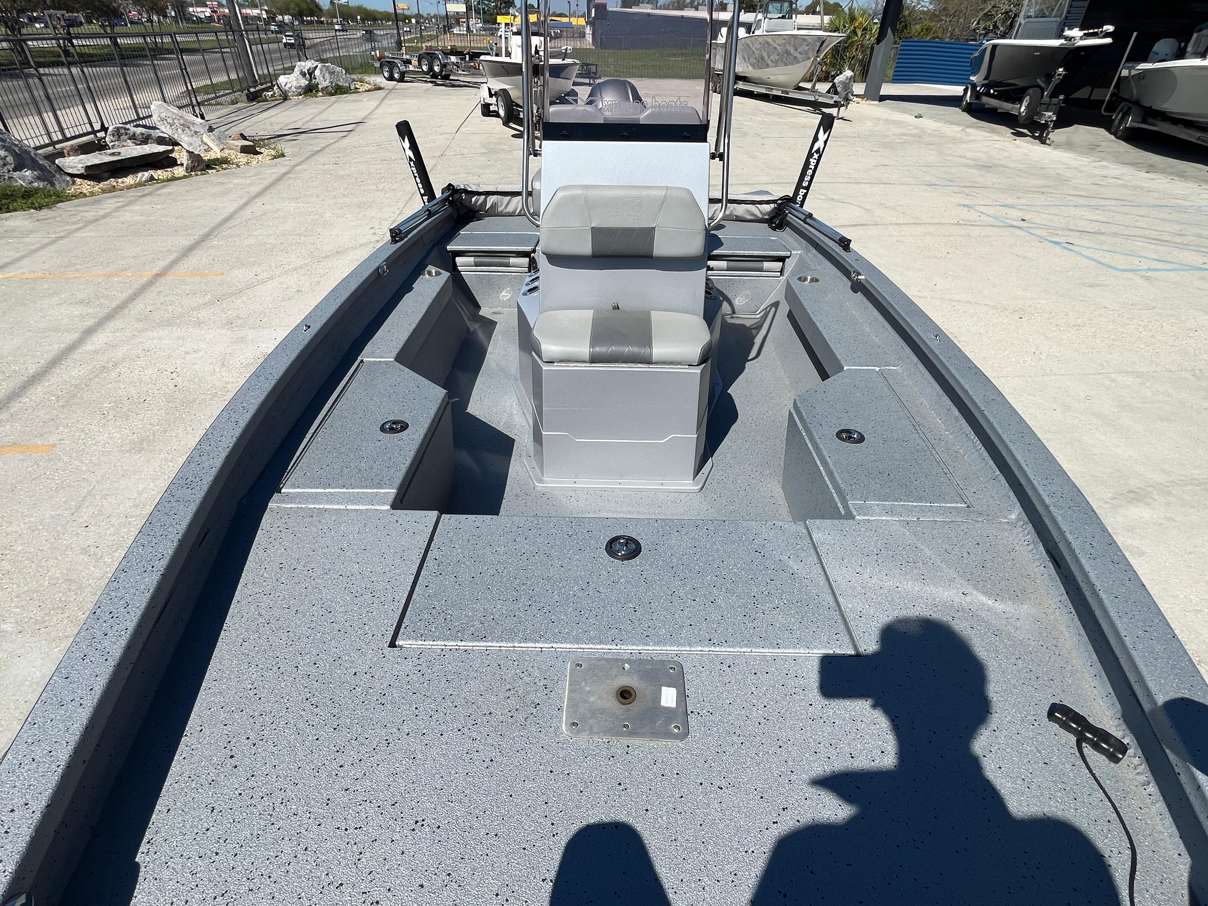 2022 Xpress H20B Bay Boat with spacious deck and seating, parked outdoors.