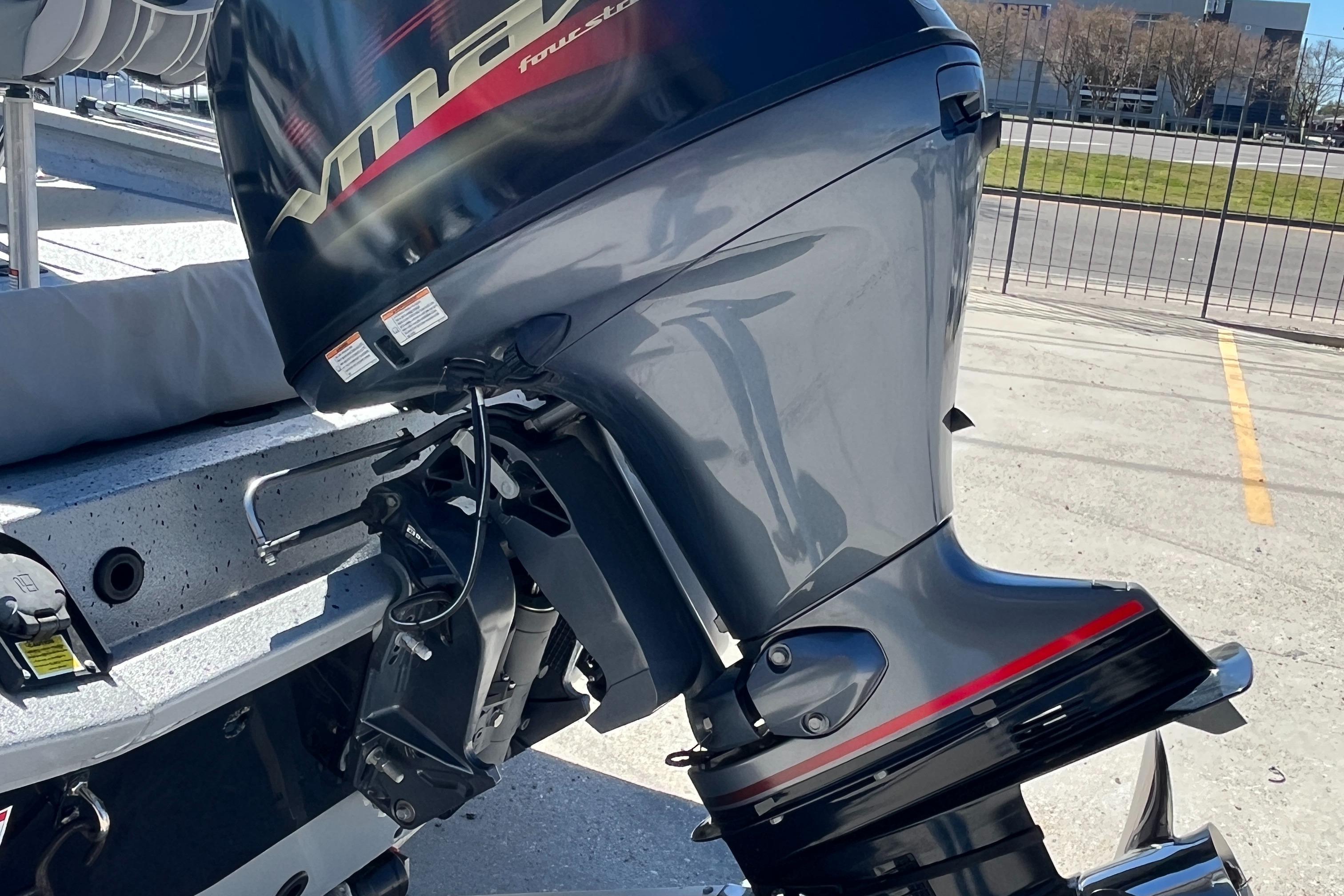 2022 Xpress H20B Bay Boat with powerful outboard motor in a parking lot.