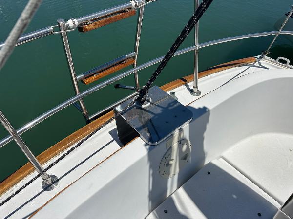 Sailboat deck detail of 1986 Nonsuch Ultra, featuring railing and winch.