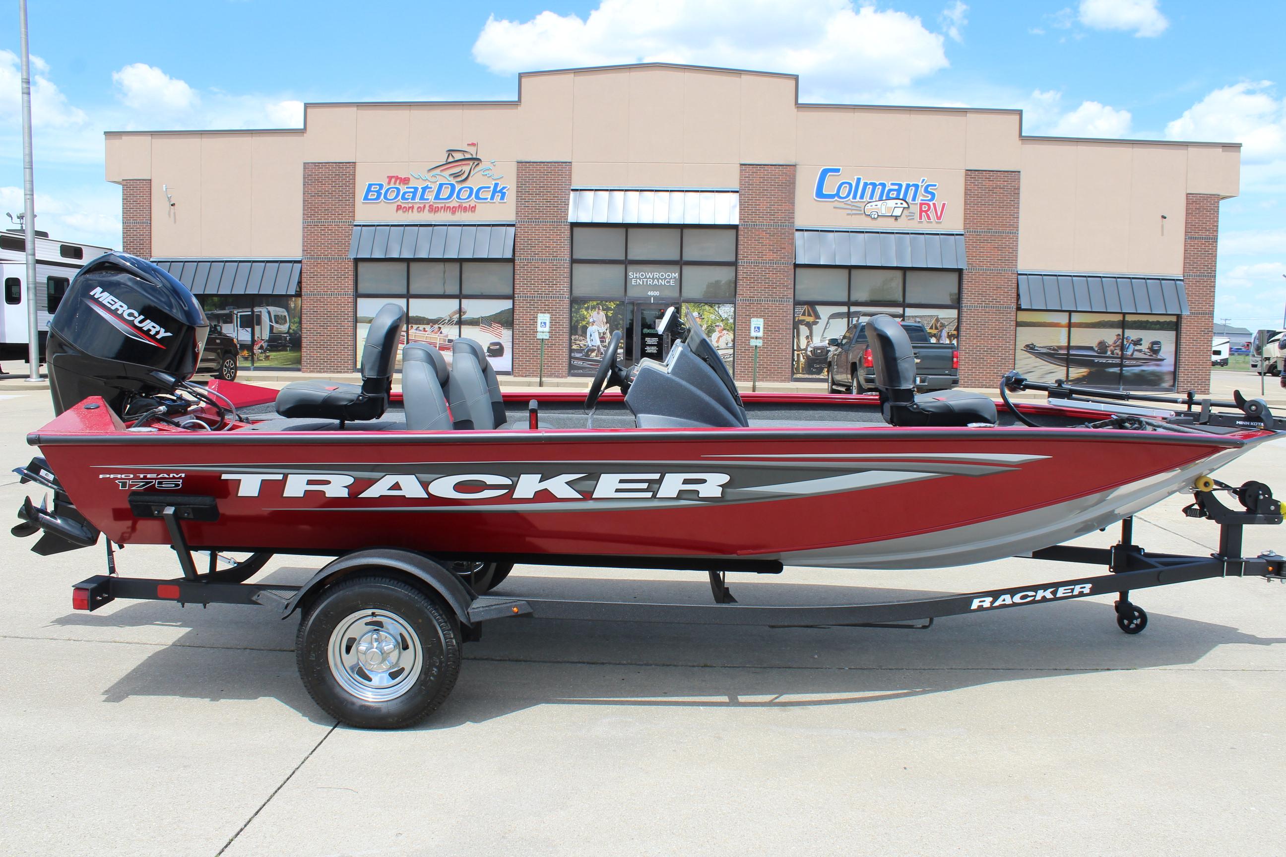 2025 Tracker Pro Team 175 boat in red, parked outside a dealership.