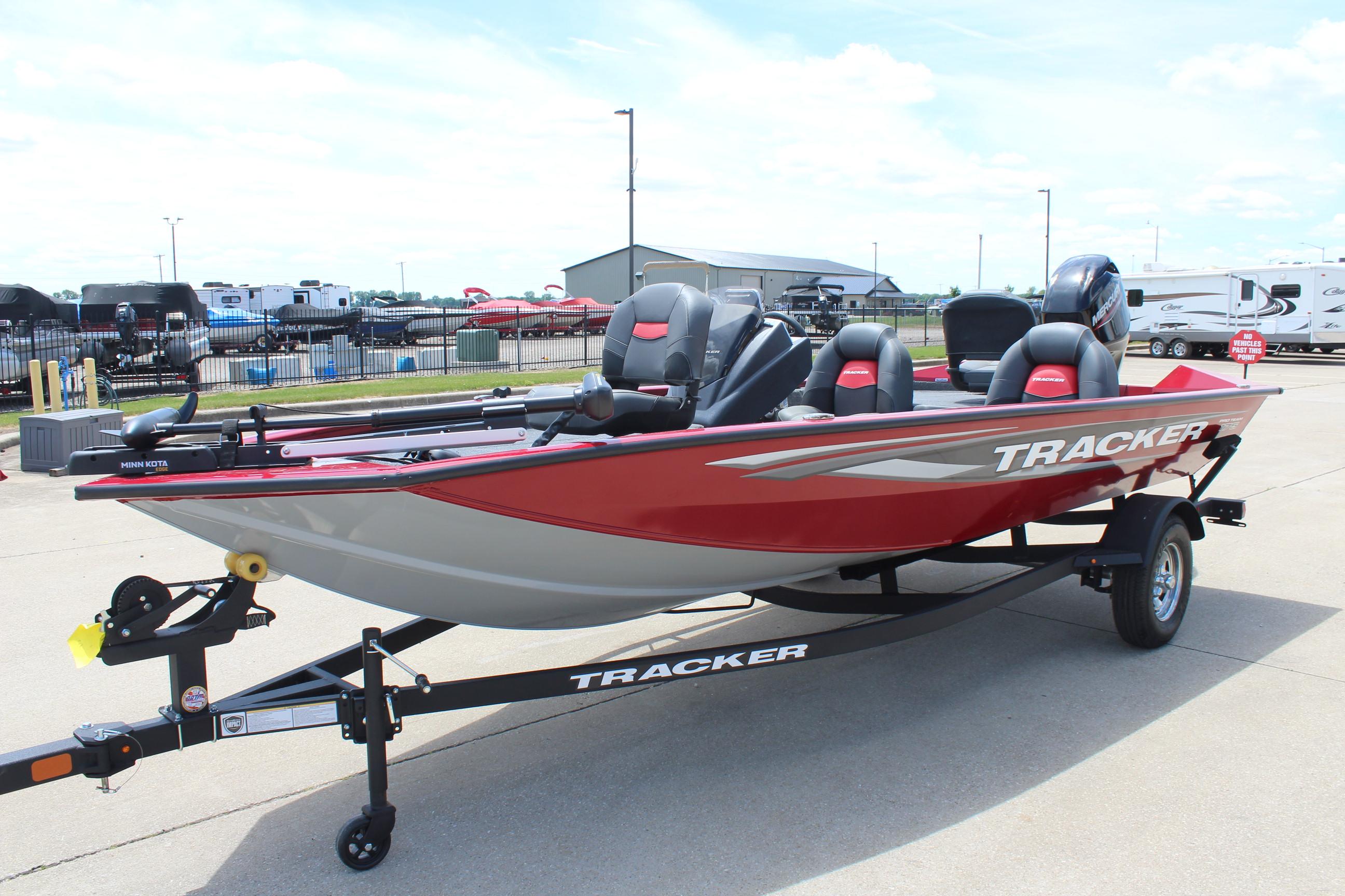 2025 Tracker Pro Team 175 boat on trailer, red and gray design, parked outdoors.