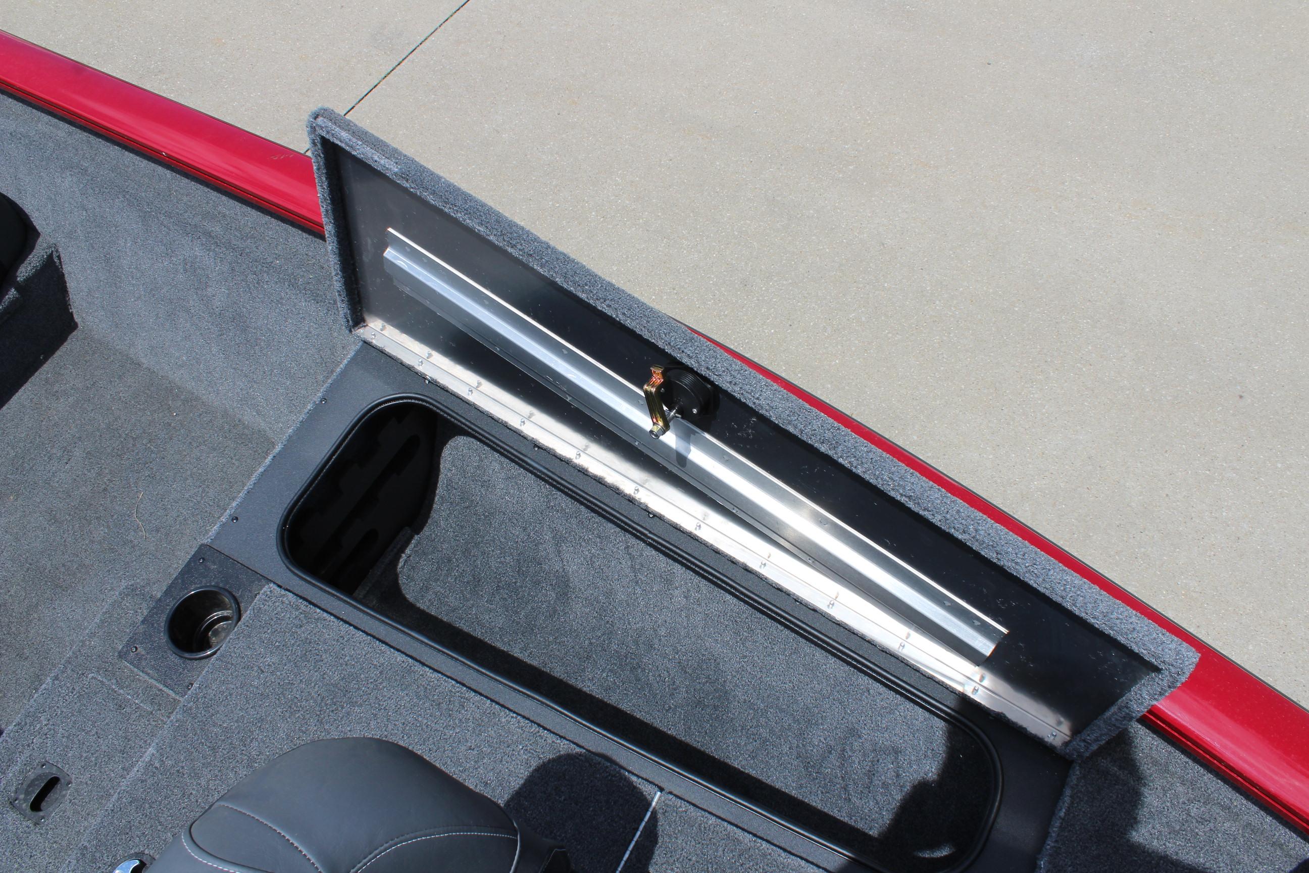 2025 Tracker Pro Team 175 boat storage compartment with open lid and measuring ruler.