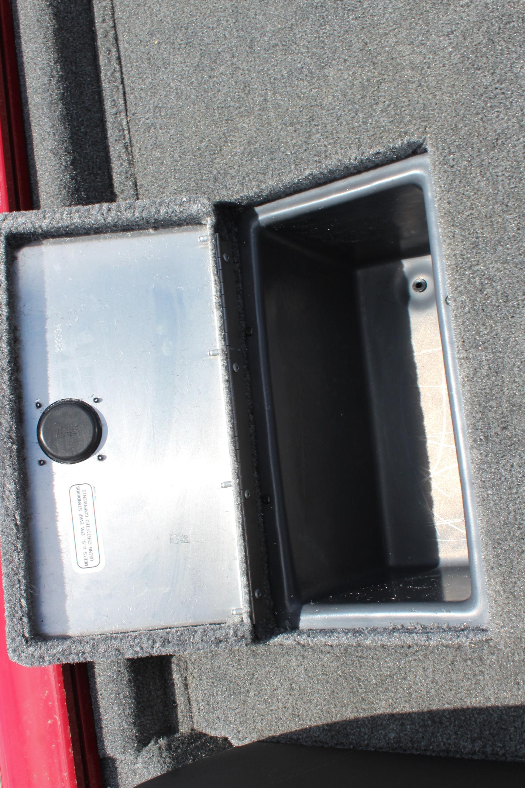 2025 Tracker Pro Team 175 boat storage compartment with gray carpeted interior.