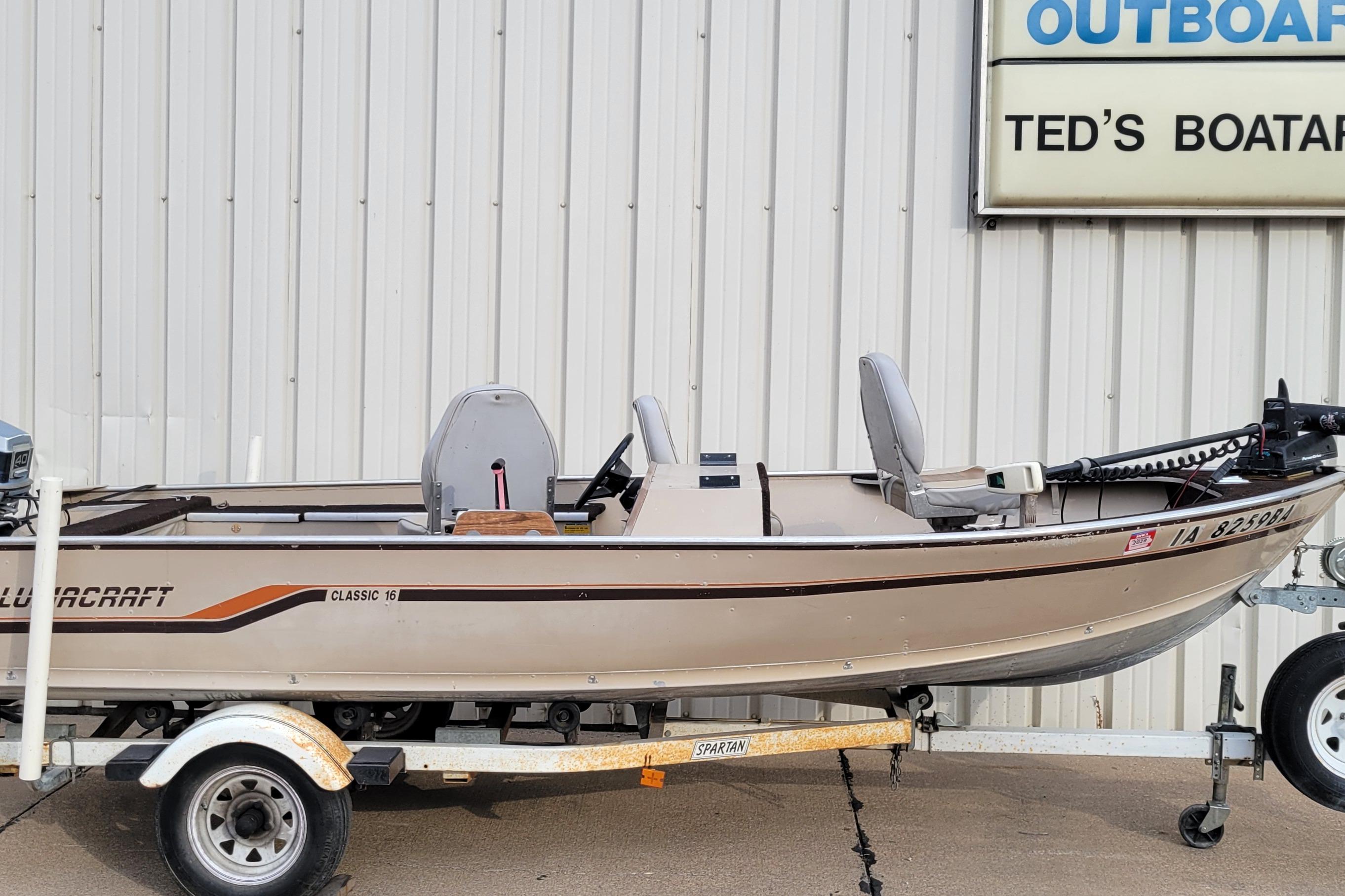 1987 Alumacraft Classic 165 CS boat on trailer, parked outside Ted's Boatarama.