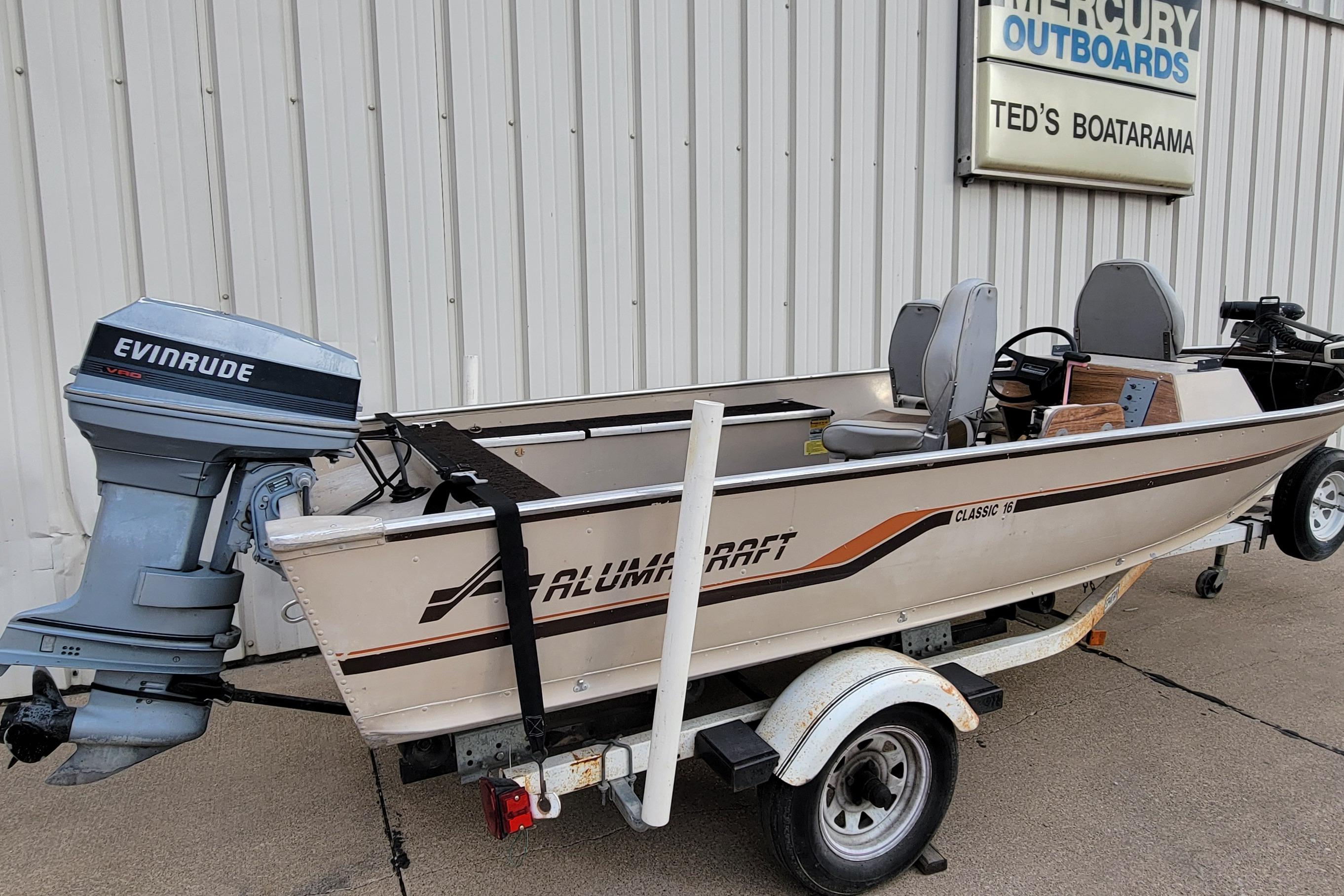 1987 Alumacraft Classic 165 CS boat with Evinrude motor on trailer at Ted's Boatarama.