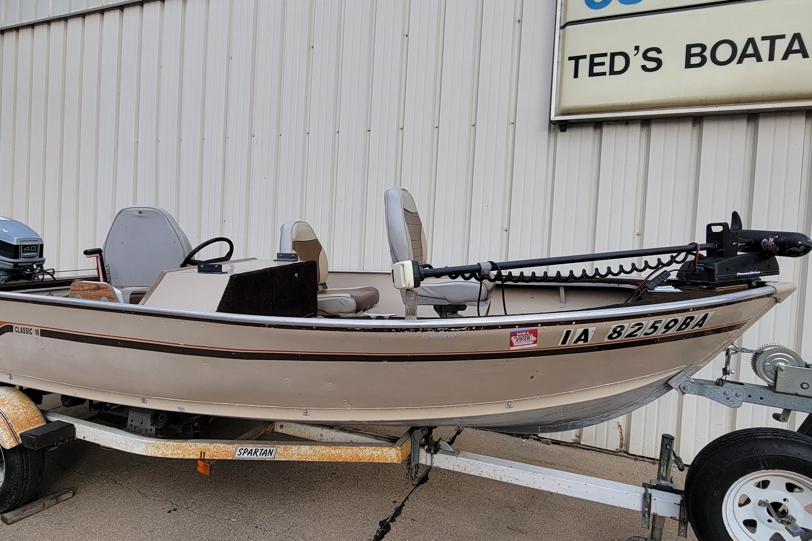 1987 Alumacraft Classic 165 CS boat on trailer, parked outside Ted's Boating.
