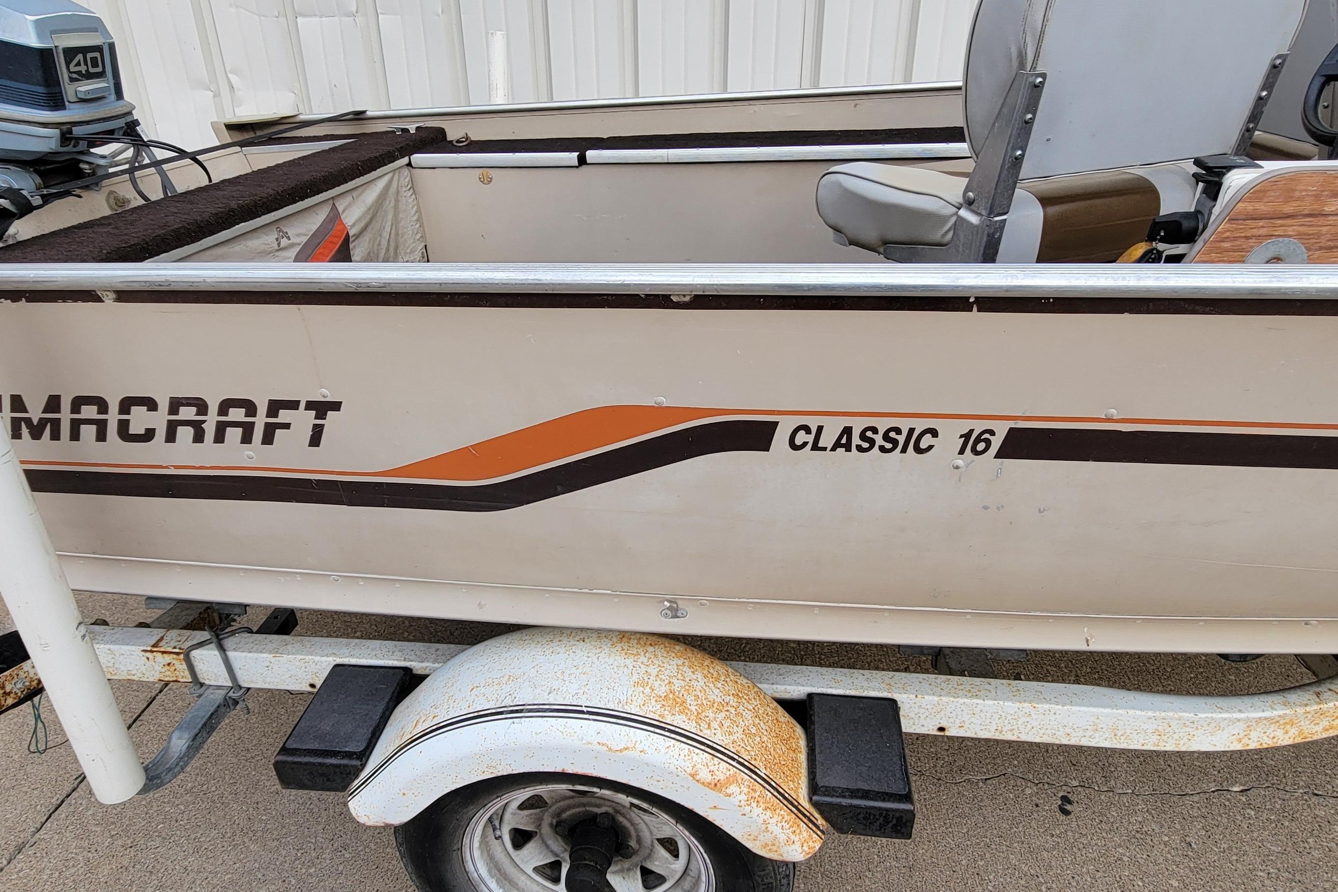 1987 Alumacraft Classic 165 CS boat on trailer, featuring vintage design and outboard motor.