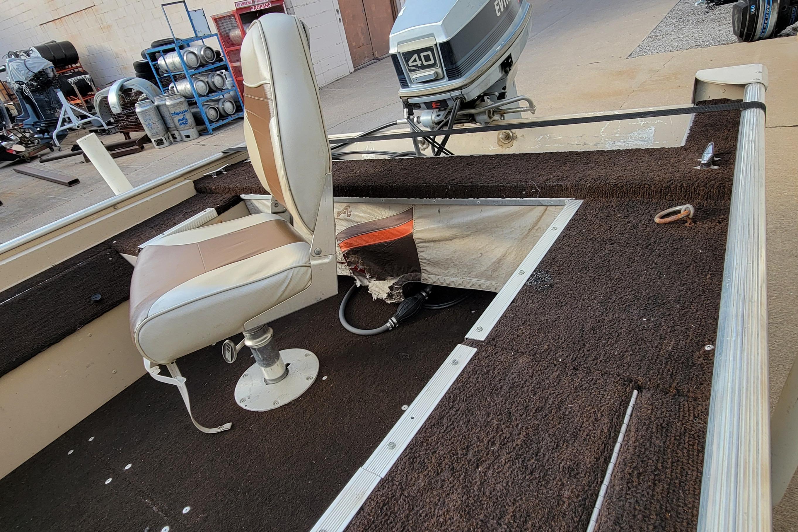 1987 Alumacraft Classic 165 CS boat interior with seating and Evinrude motor.