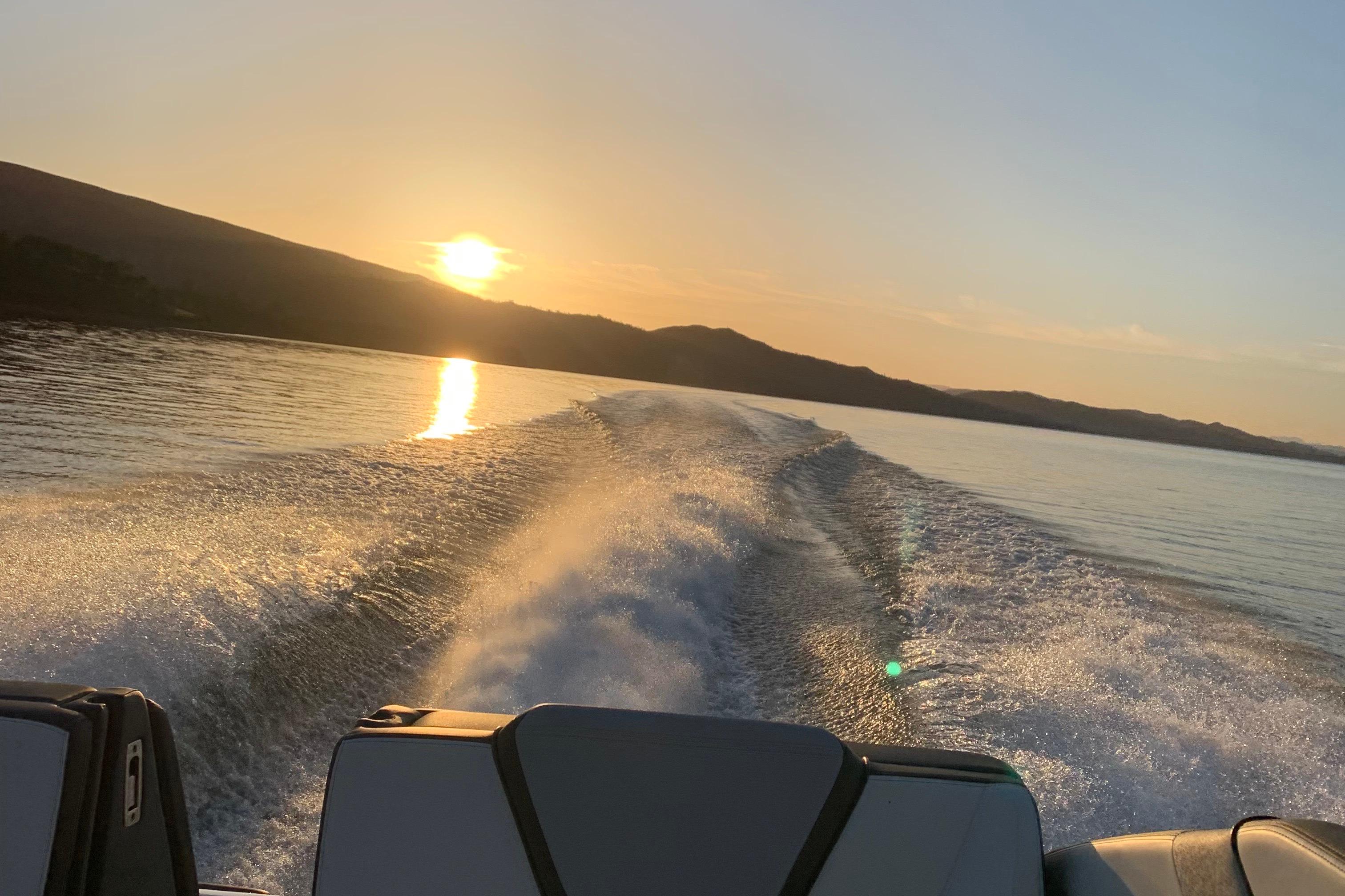 Yamaha Boats 252S (2022) cruising at sunset, creating a scenic wake on the water.