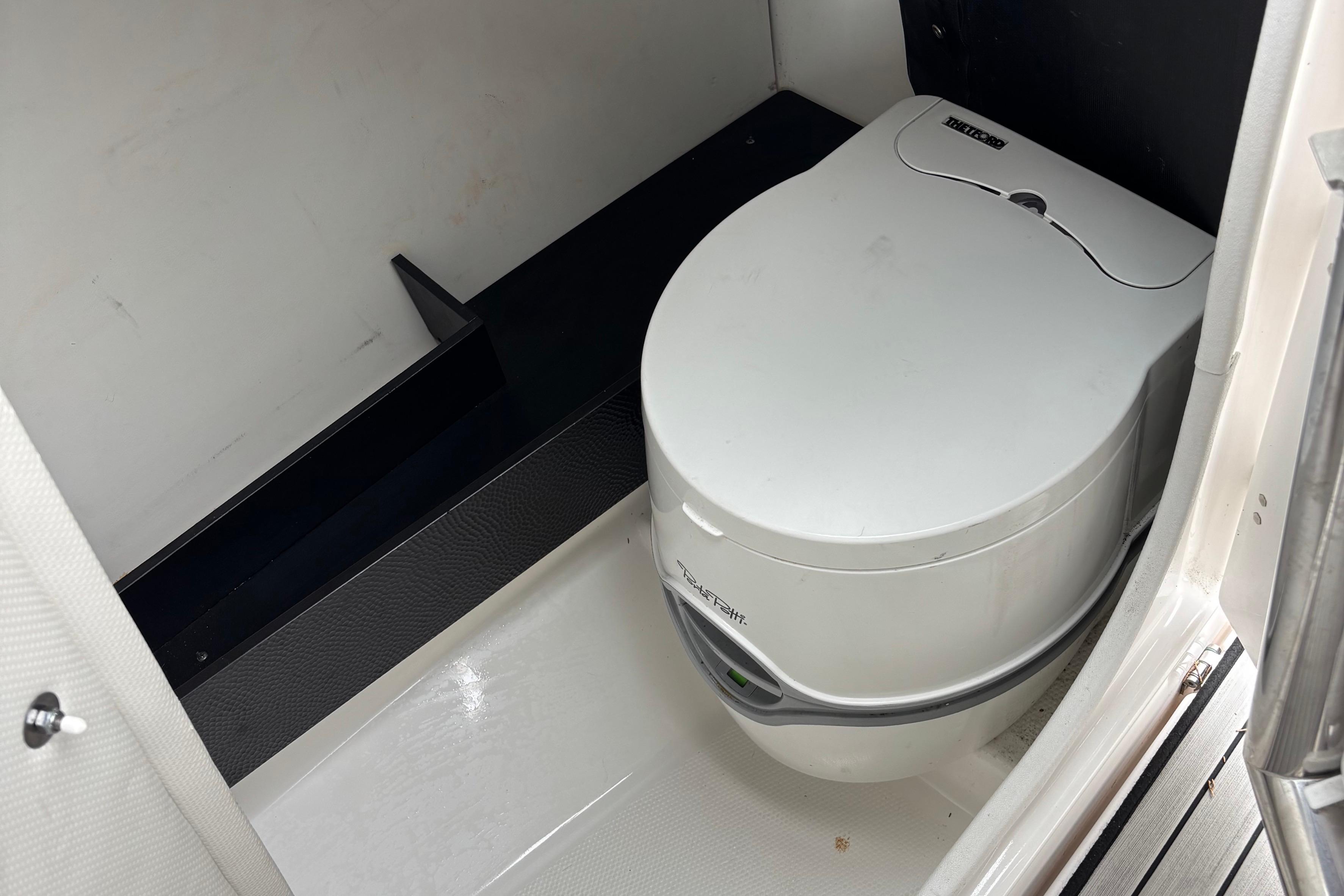 2022 Yamaha Boats 252S interior with compact marine toilet.