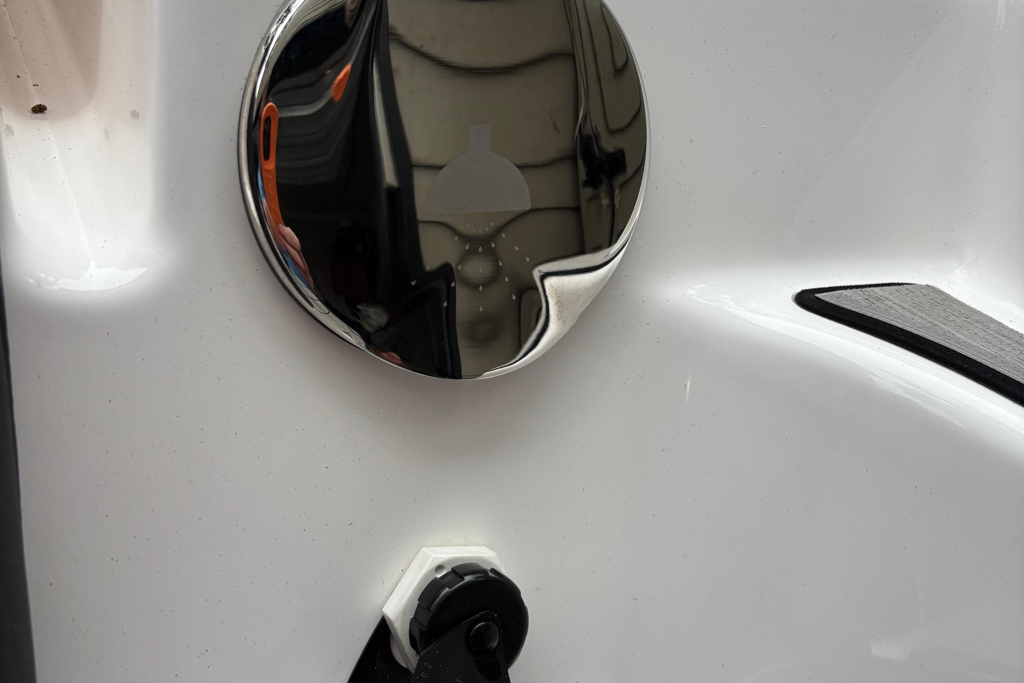 Close-up of a 2022 Yamaha Boats 252S chrome and white exterior detail.