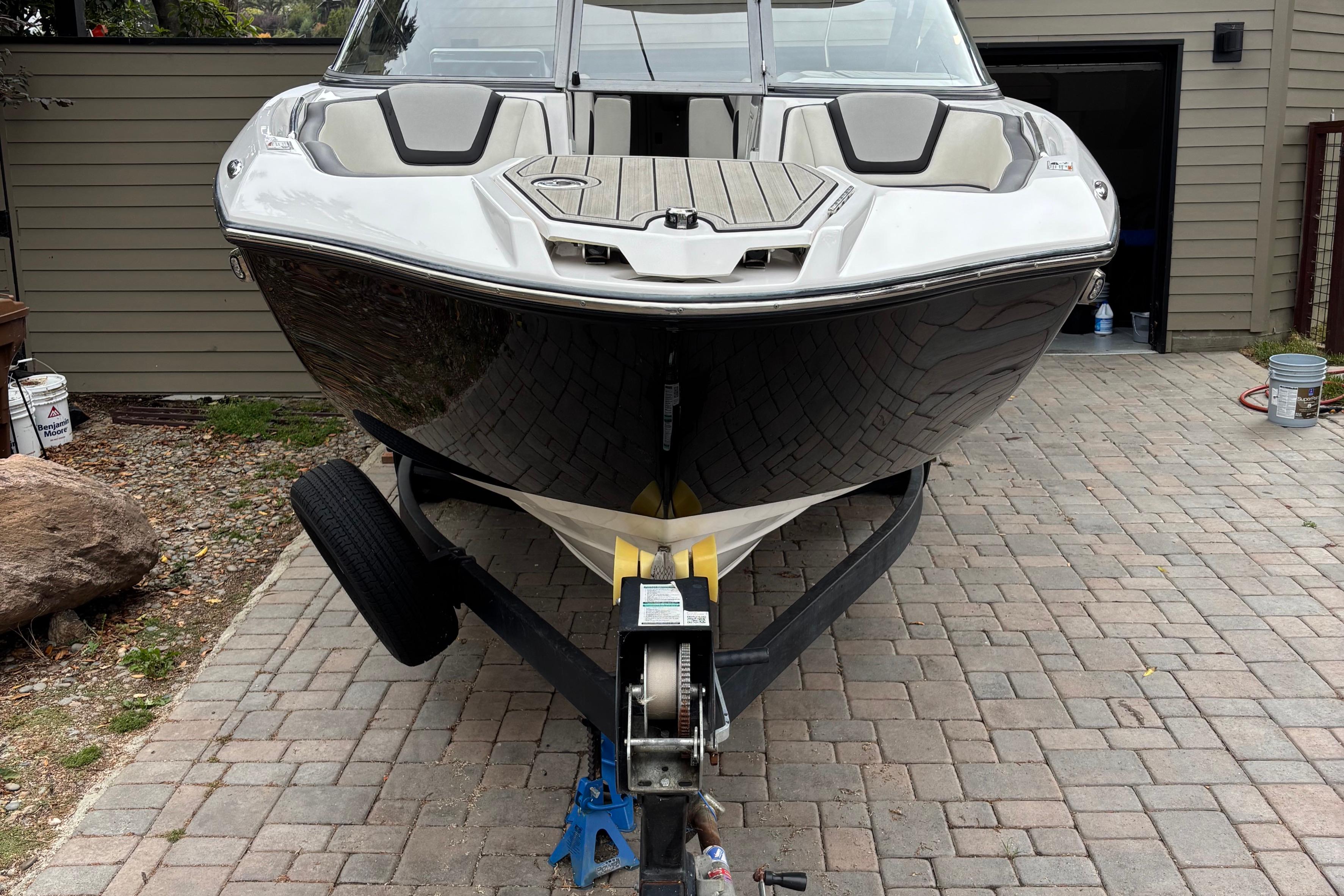 2022 Yamaha Boats 252S on trailer, parked on brick driveway.