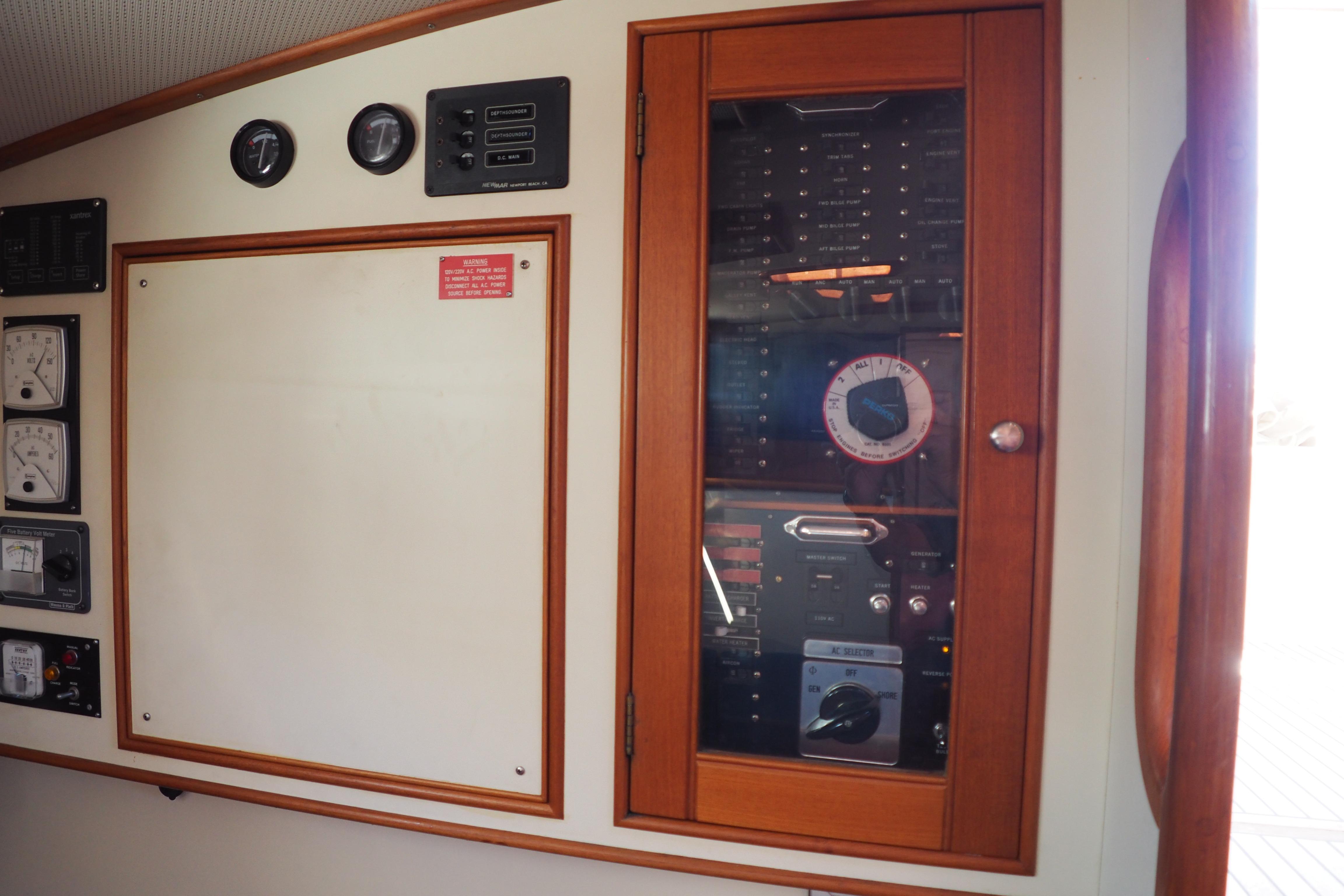 Control panel of 1995 Grand Banks 38 Eastbay EX yacht with gauges and switches.