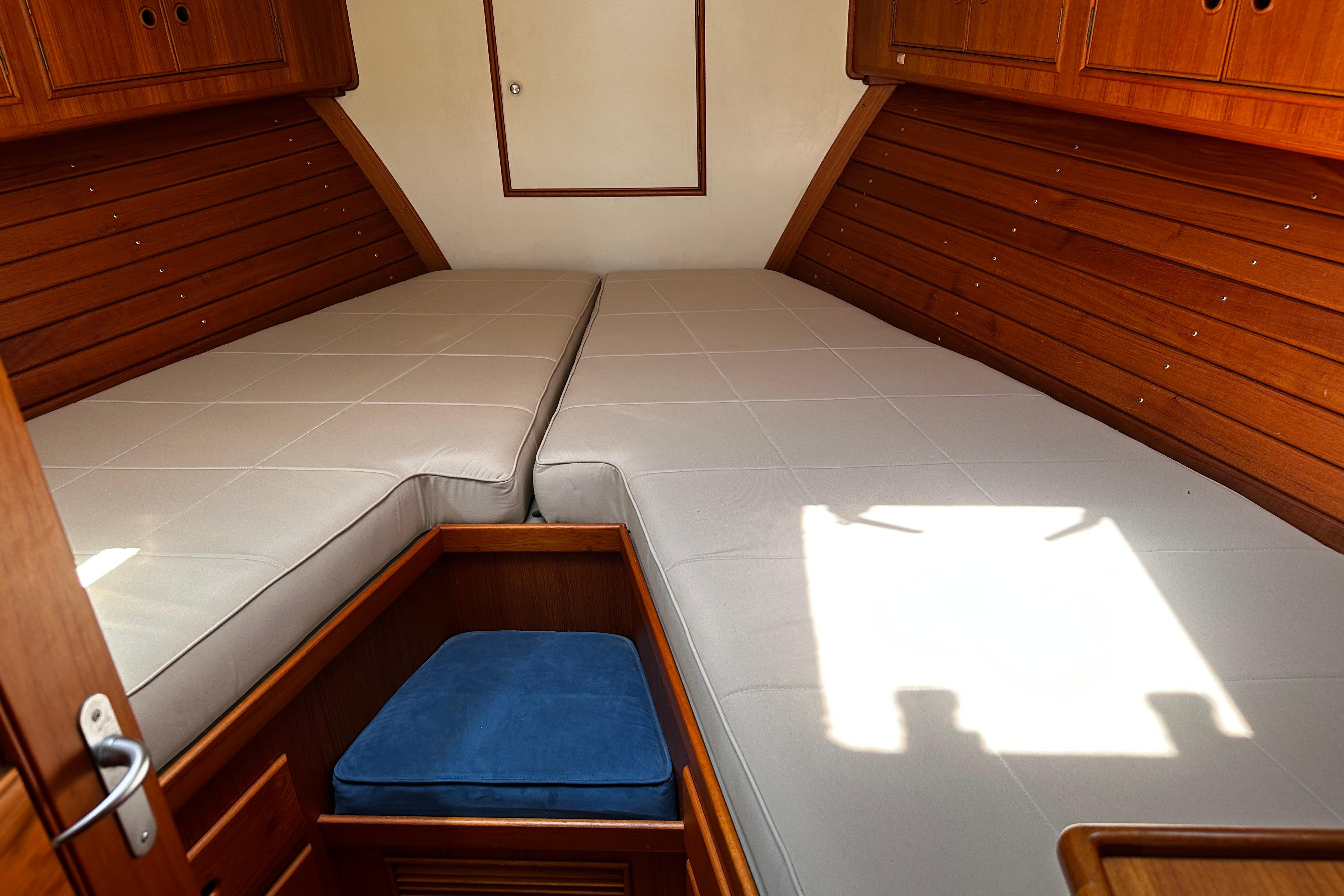 Cozy cabin interior of 1995 Grand Banks 38 Eastbay EX with twin beds and wooden finish.